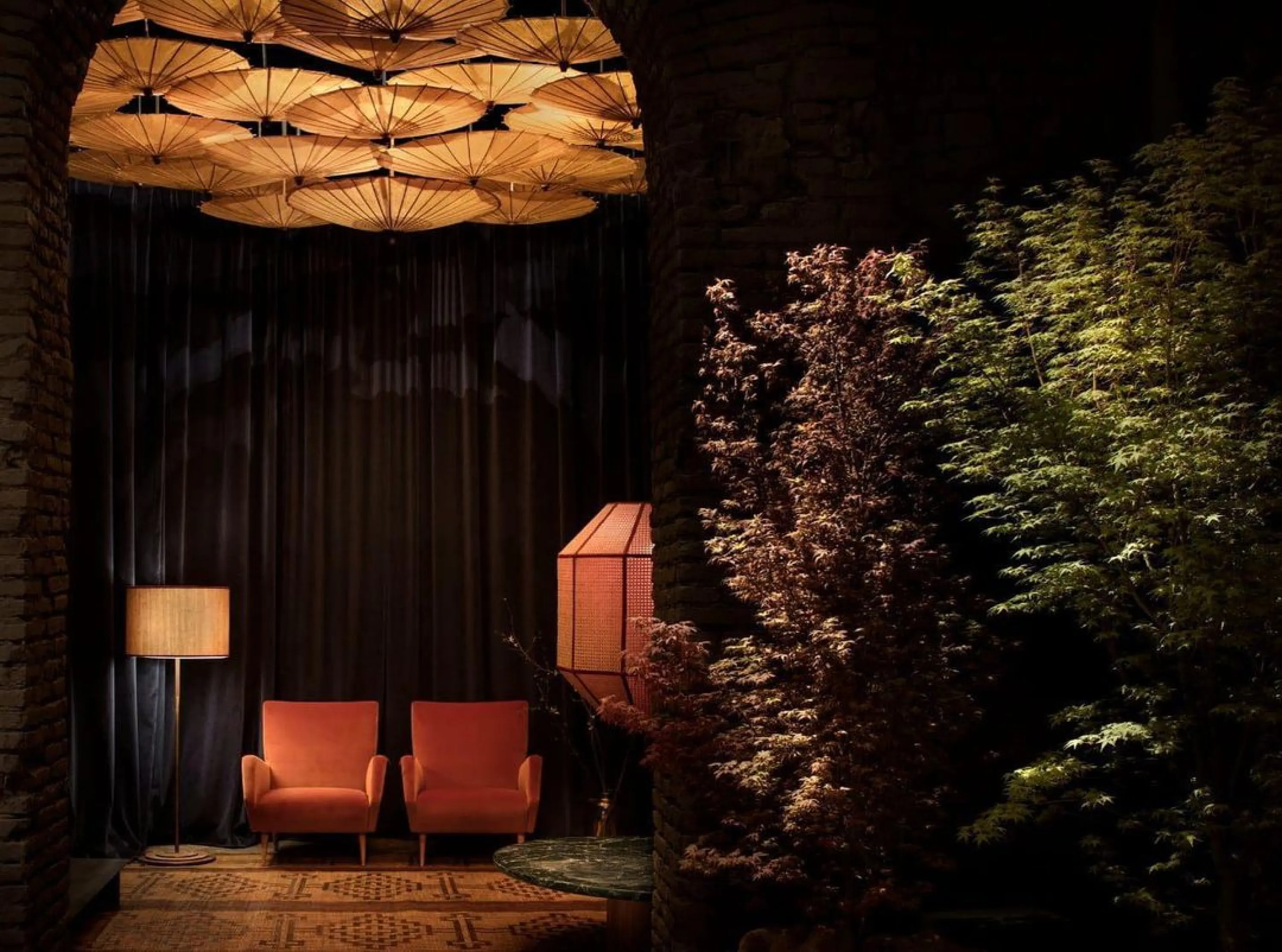 View into a side room with paper umbrellas hanging from the ceiling.