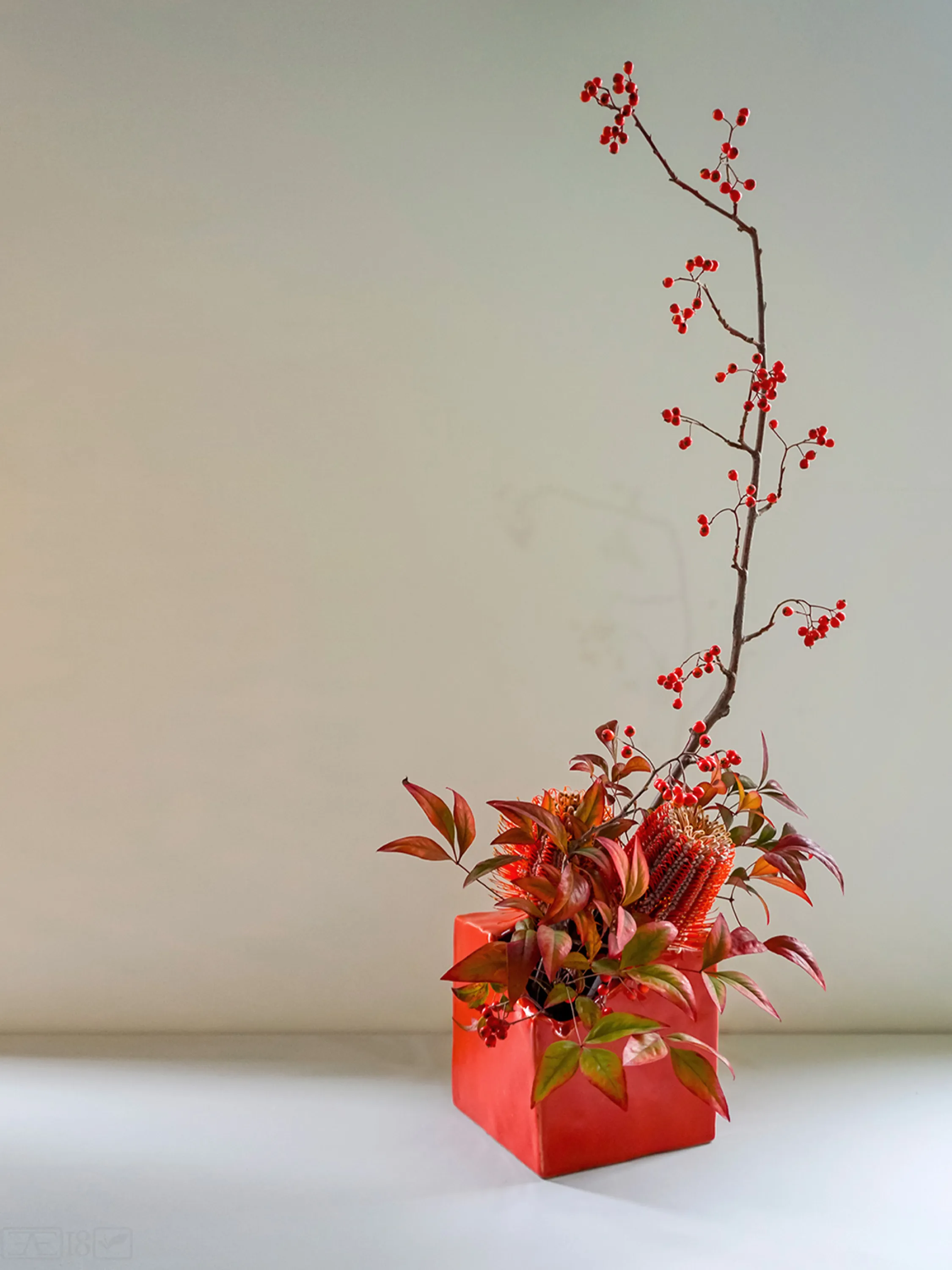 Asymmetric Ikebana arrangement with berries.