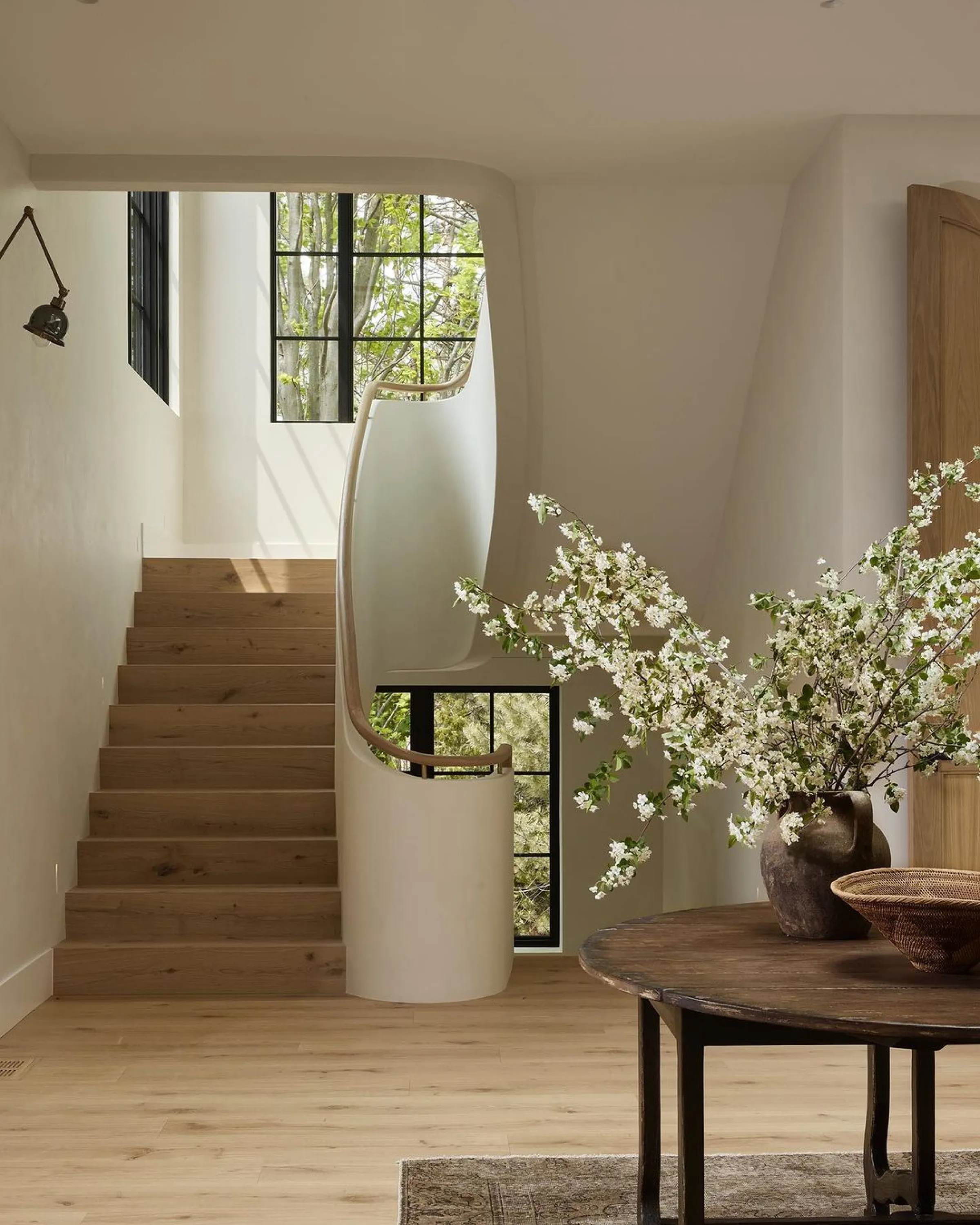 Curved staircase overlooking greenery.