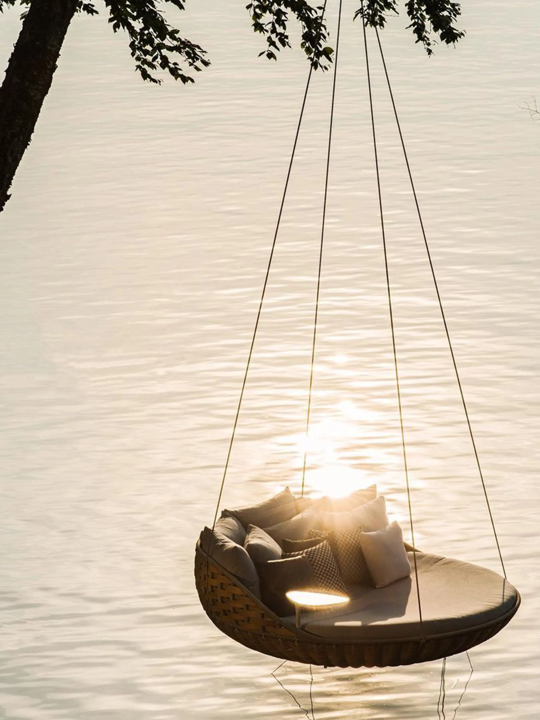Hanging chair over a water body.