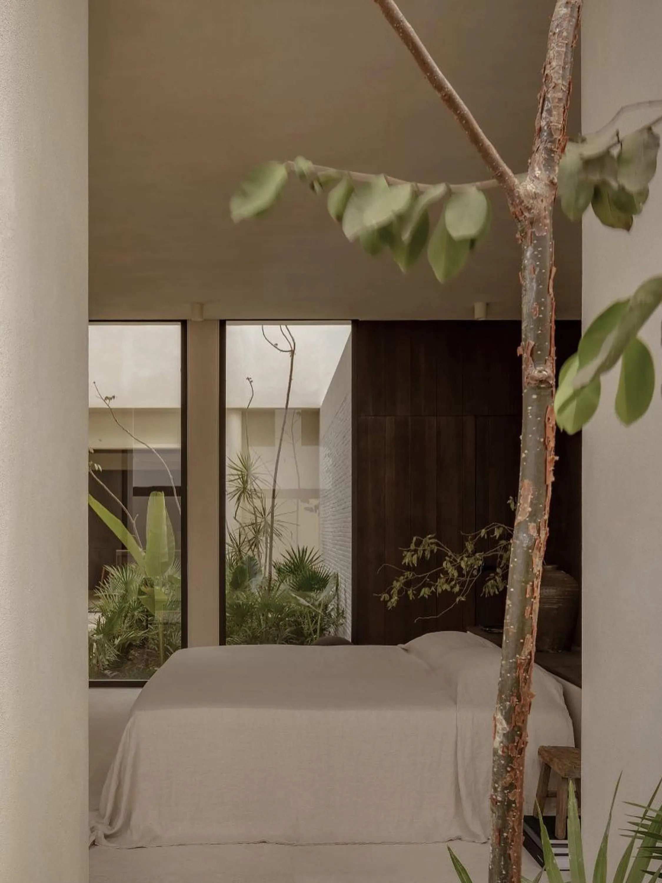 Bedroom overlooking an indoor courtyard.