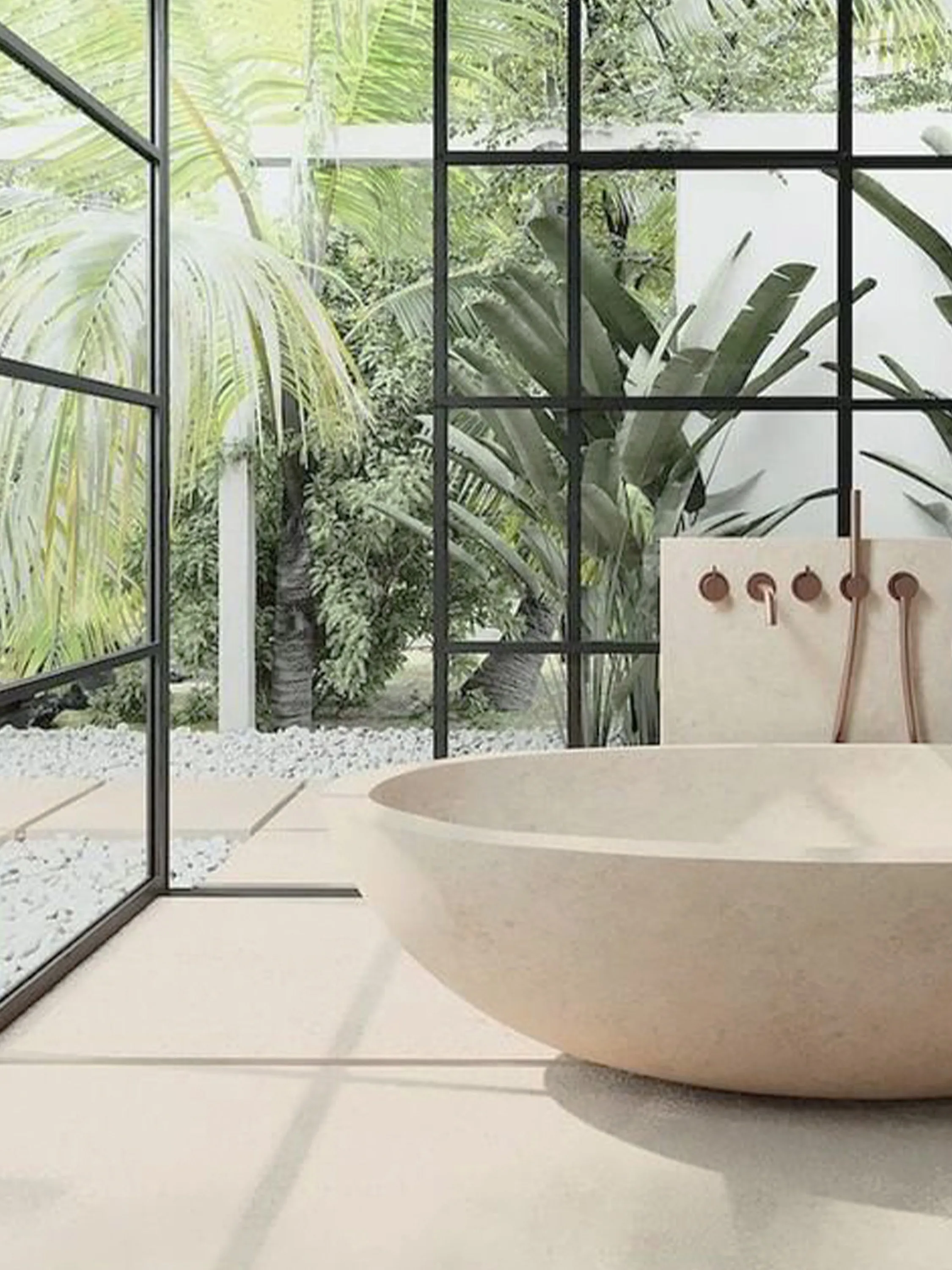 A bathtub looking into a private garden.