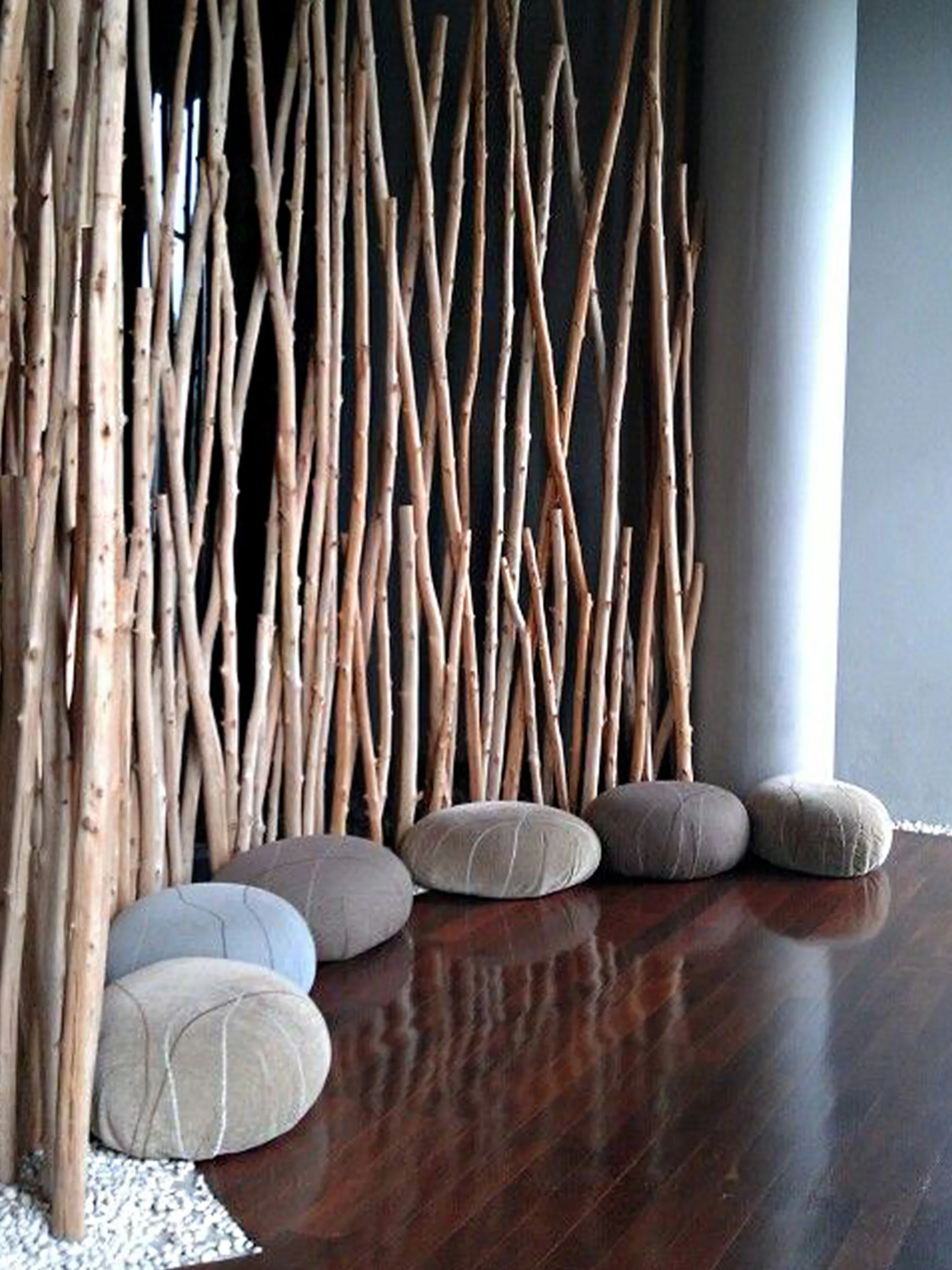 Meditation room tall organic branches zoning the space.