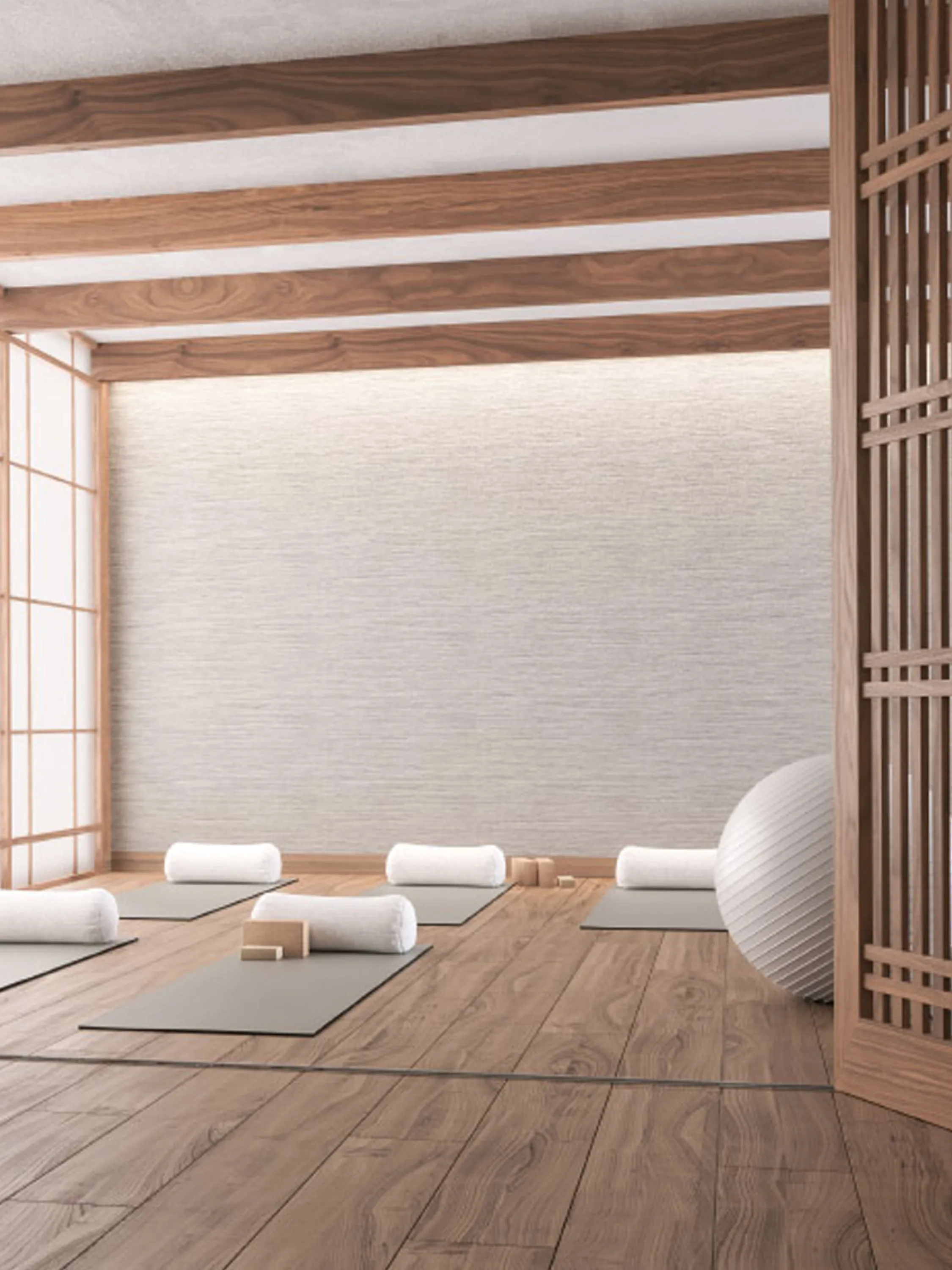 Meditation room with wooden floor and beams and a soft natural light glowing in.