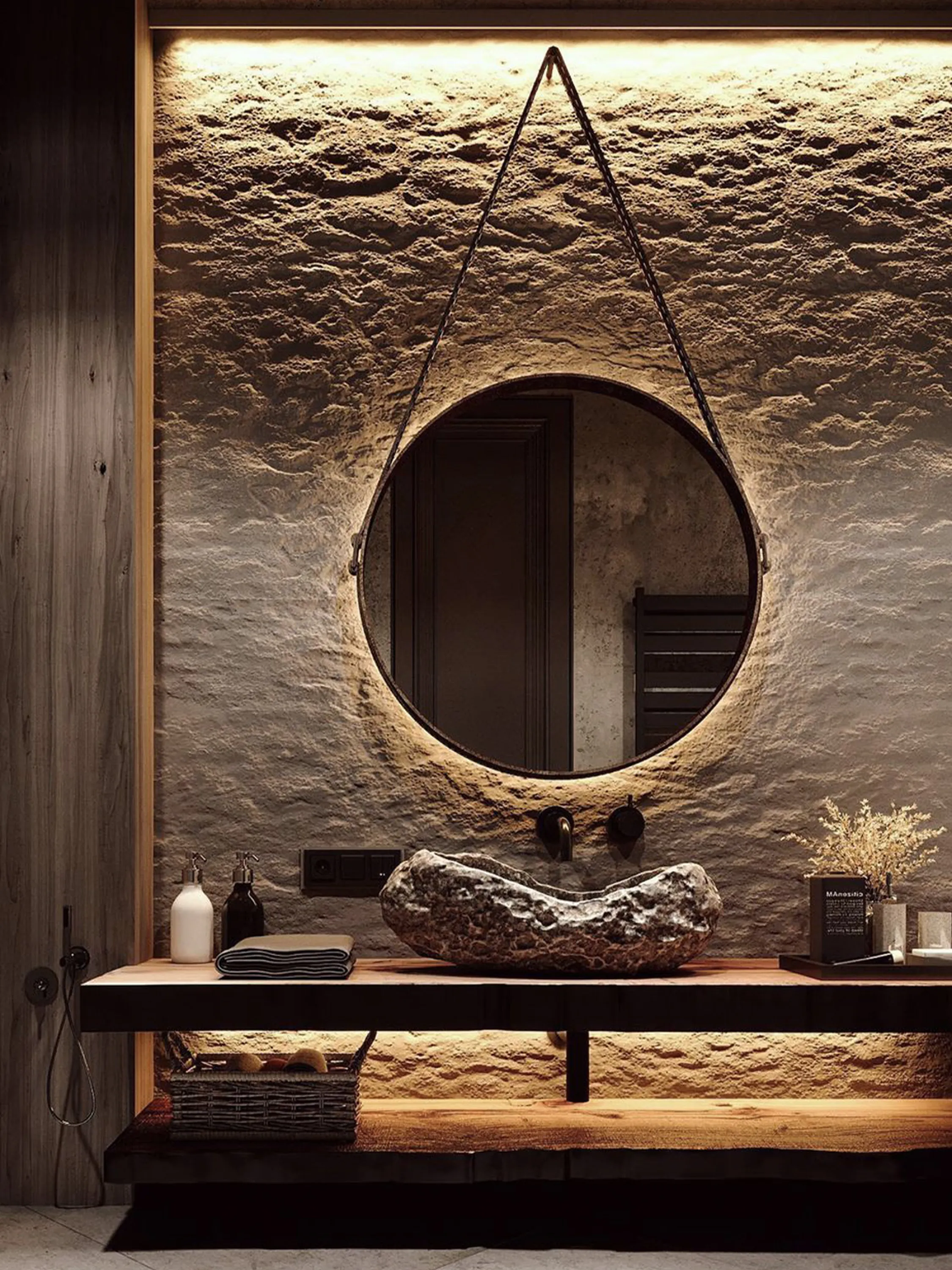 Bathroom with rough stone wall and a stone sink.