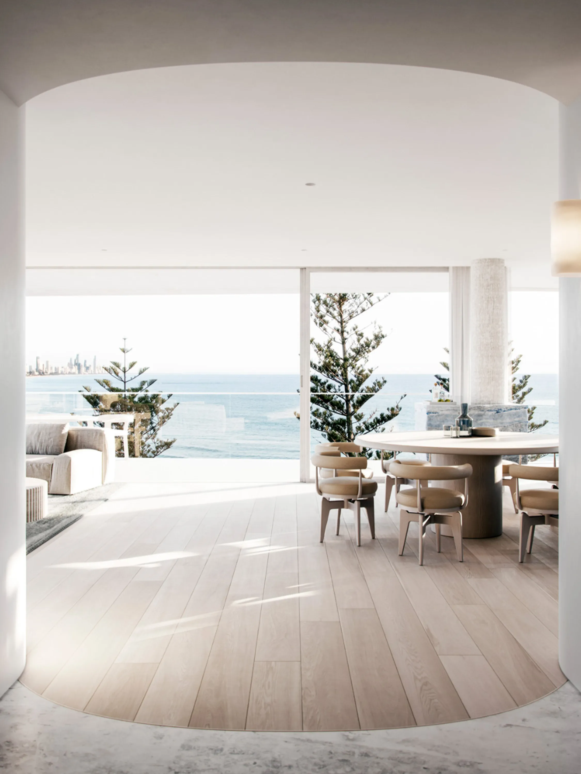 Living room with full-height windows looking at the ocean.