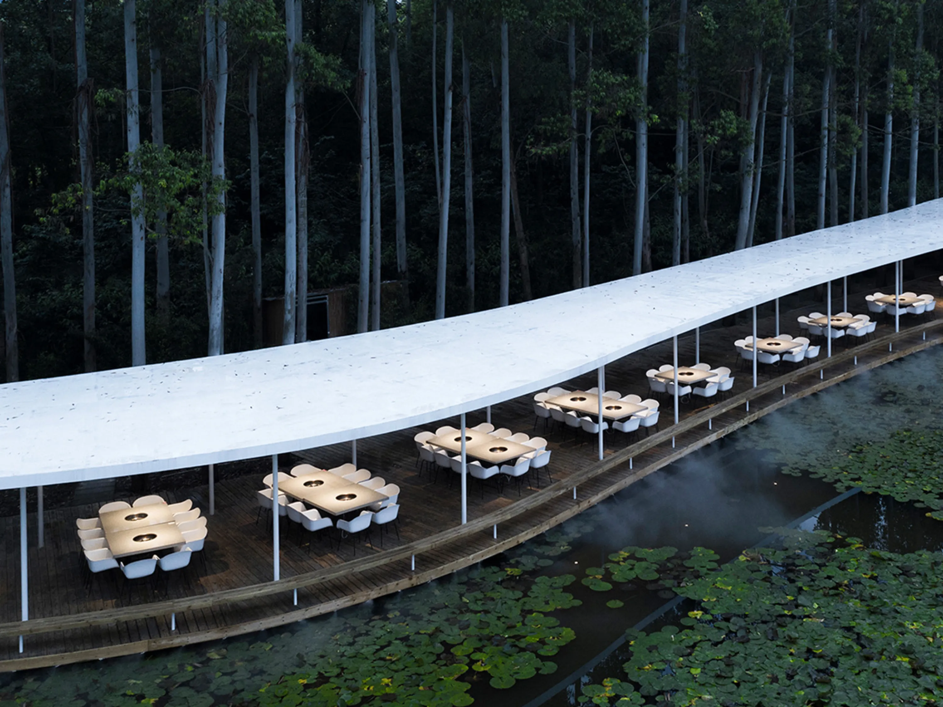 Corridor restaurant with flowy layout running in the middle of a forest.