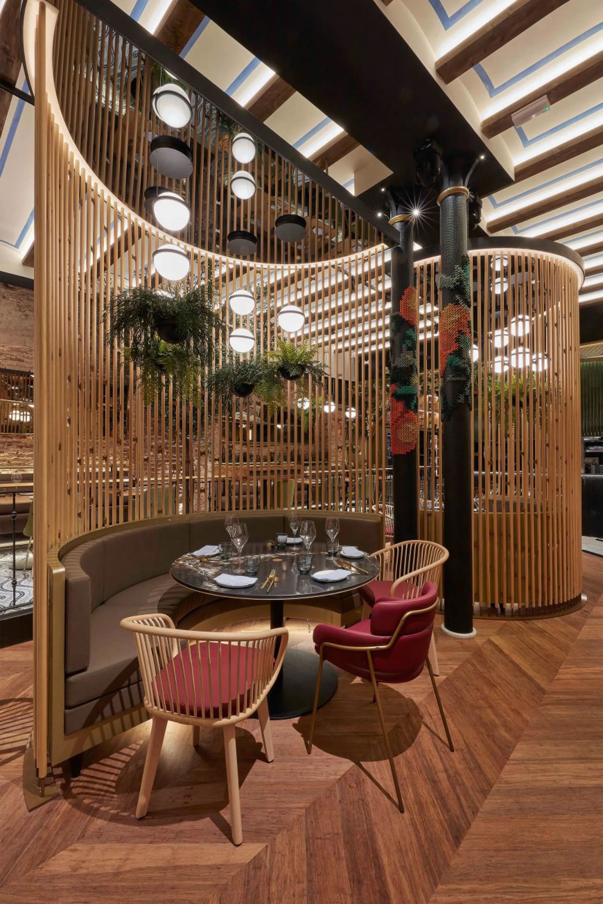Table enclosed by a floor-to-ceiling curved room divider.