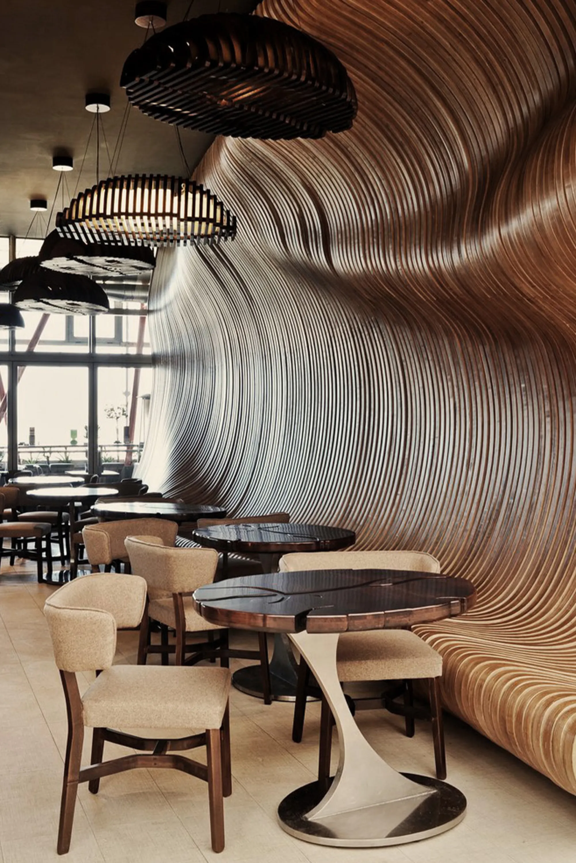 Restaurant with organic wall that doubles as seat.