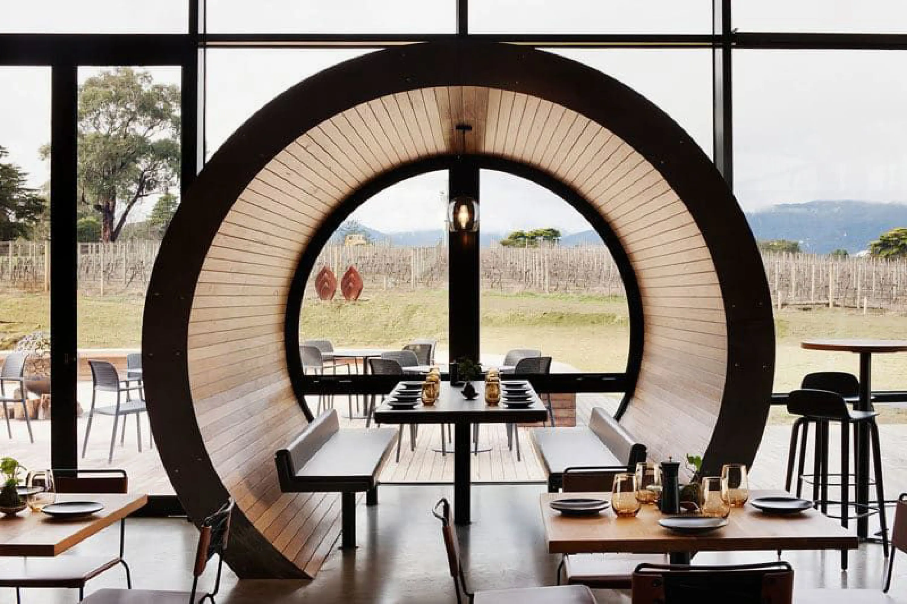 Restaurant table enclosed in a rounded wood structure.