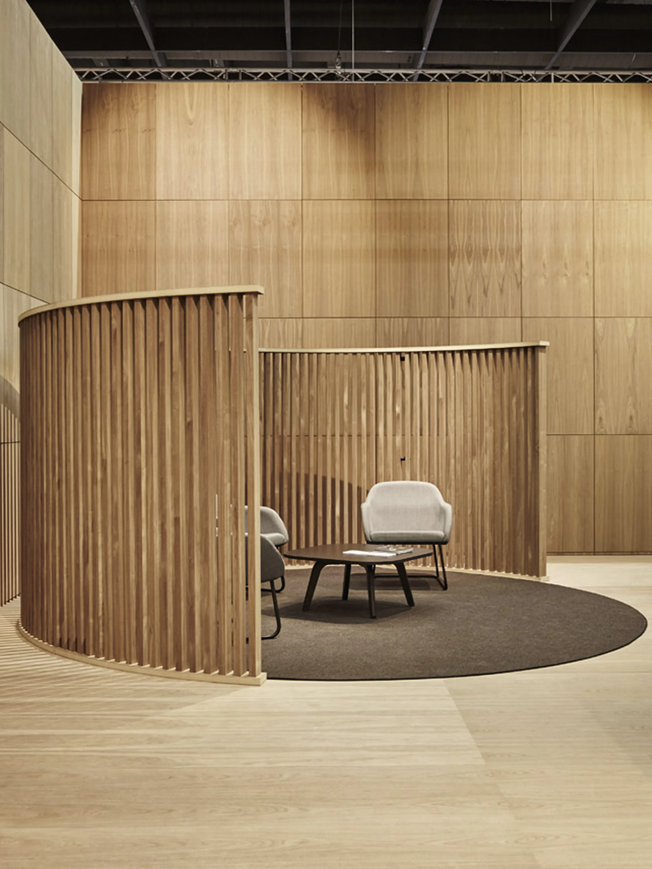 Conversation area enclosed in a wooden curved structure.