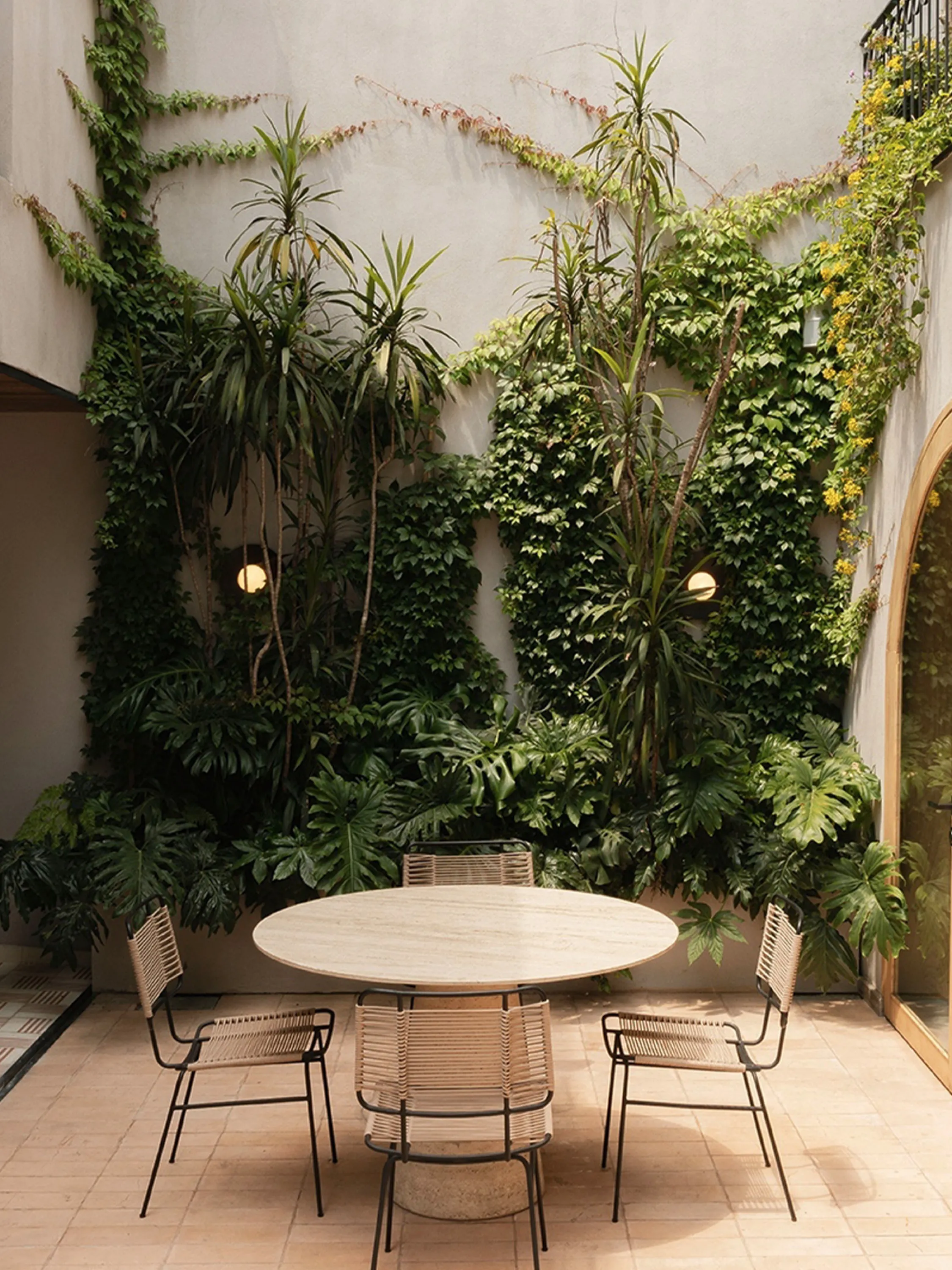 Outdoor patio with planted back wall.