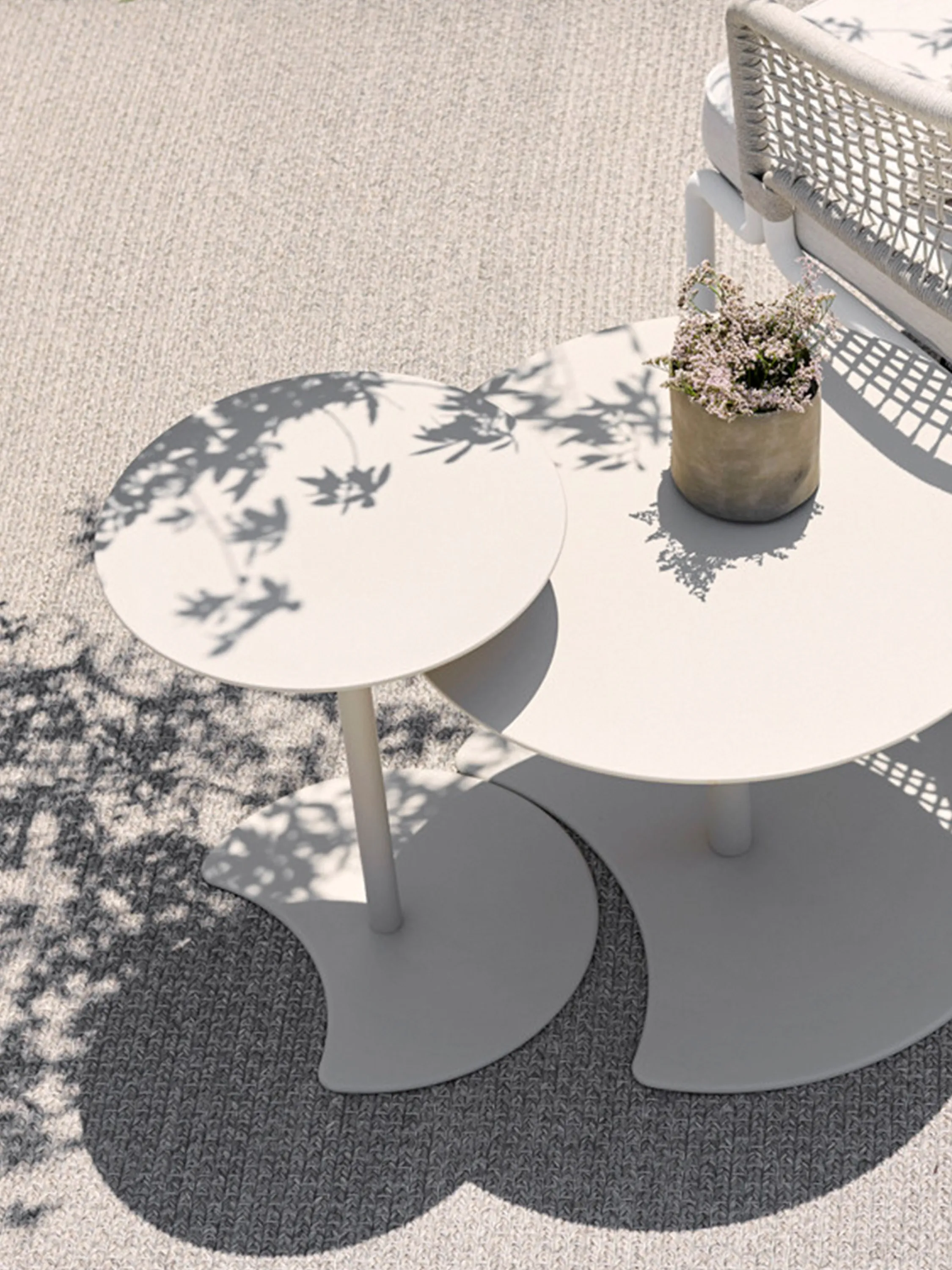 Branches reflecting on outdoor tables.