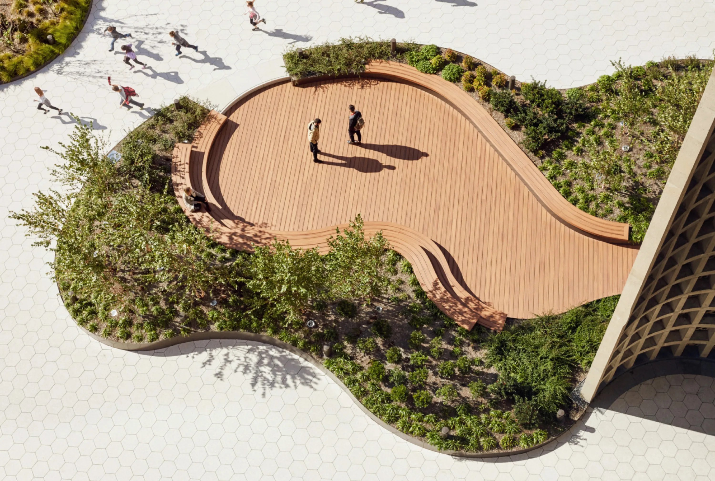 Planted urban area creating a public meeting space.