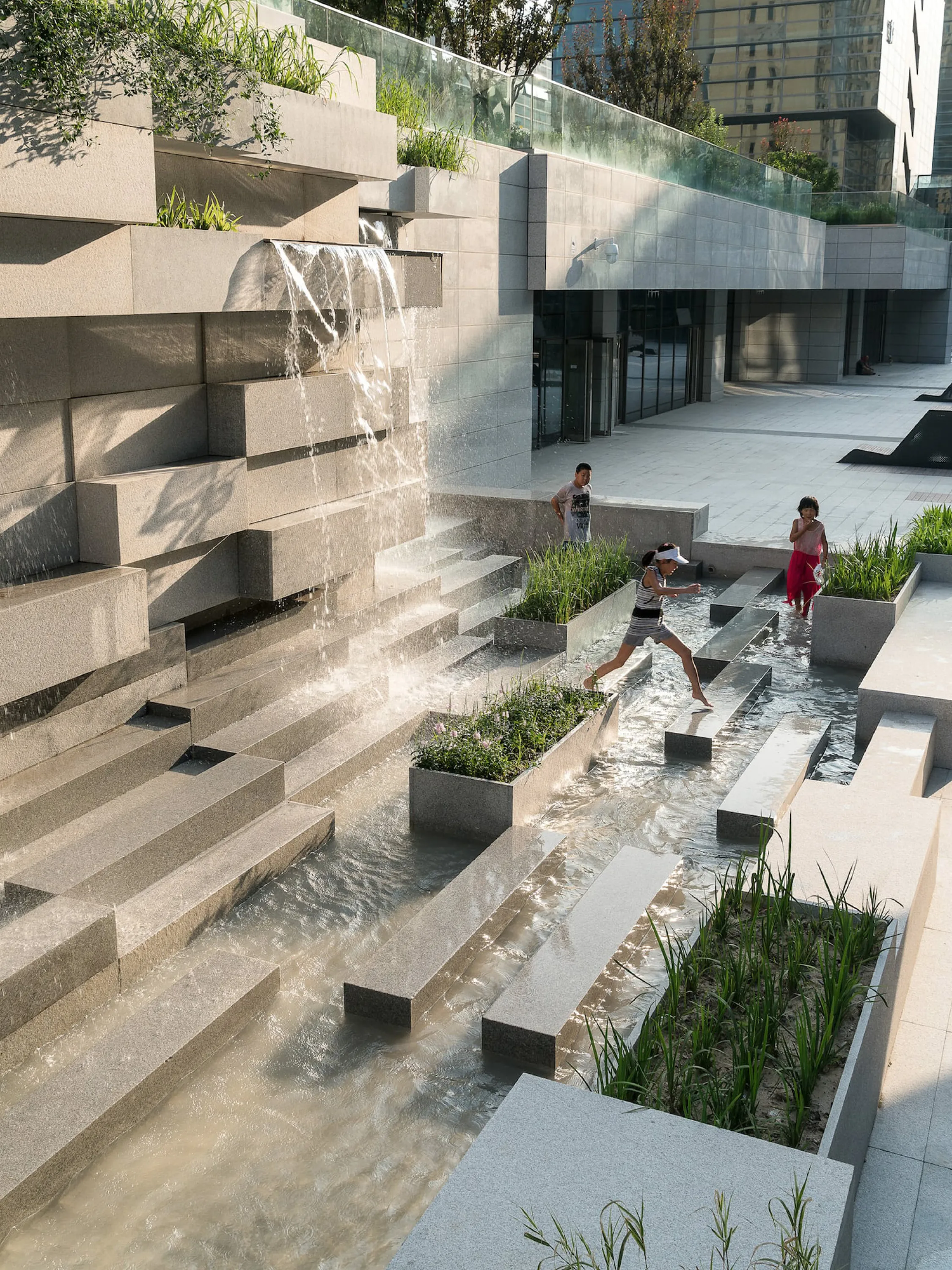 Water feature in a city inviting people to play.
