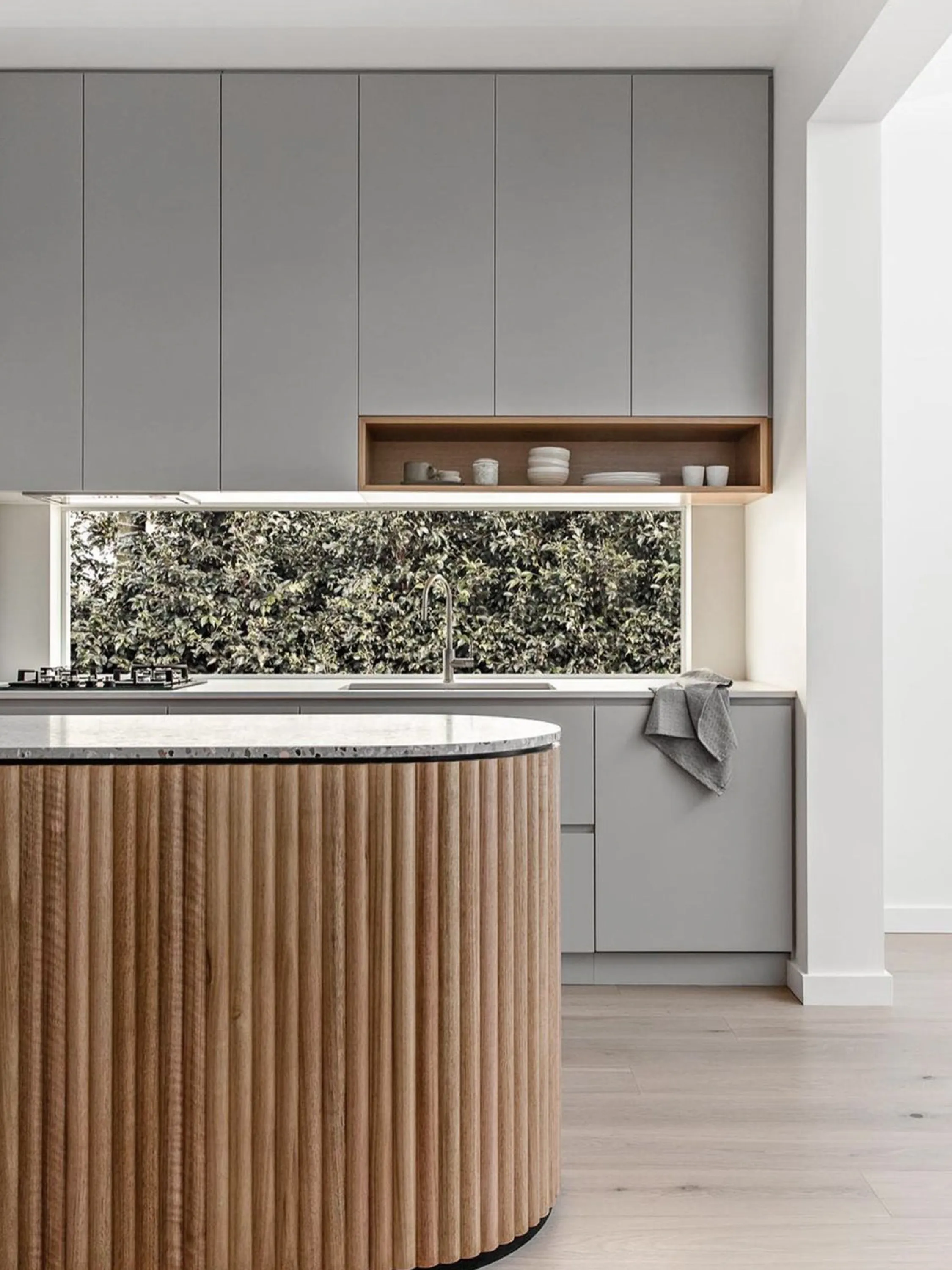 Contemporary kitchen with a window as backsplash.