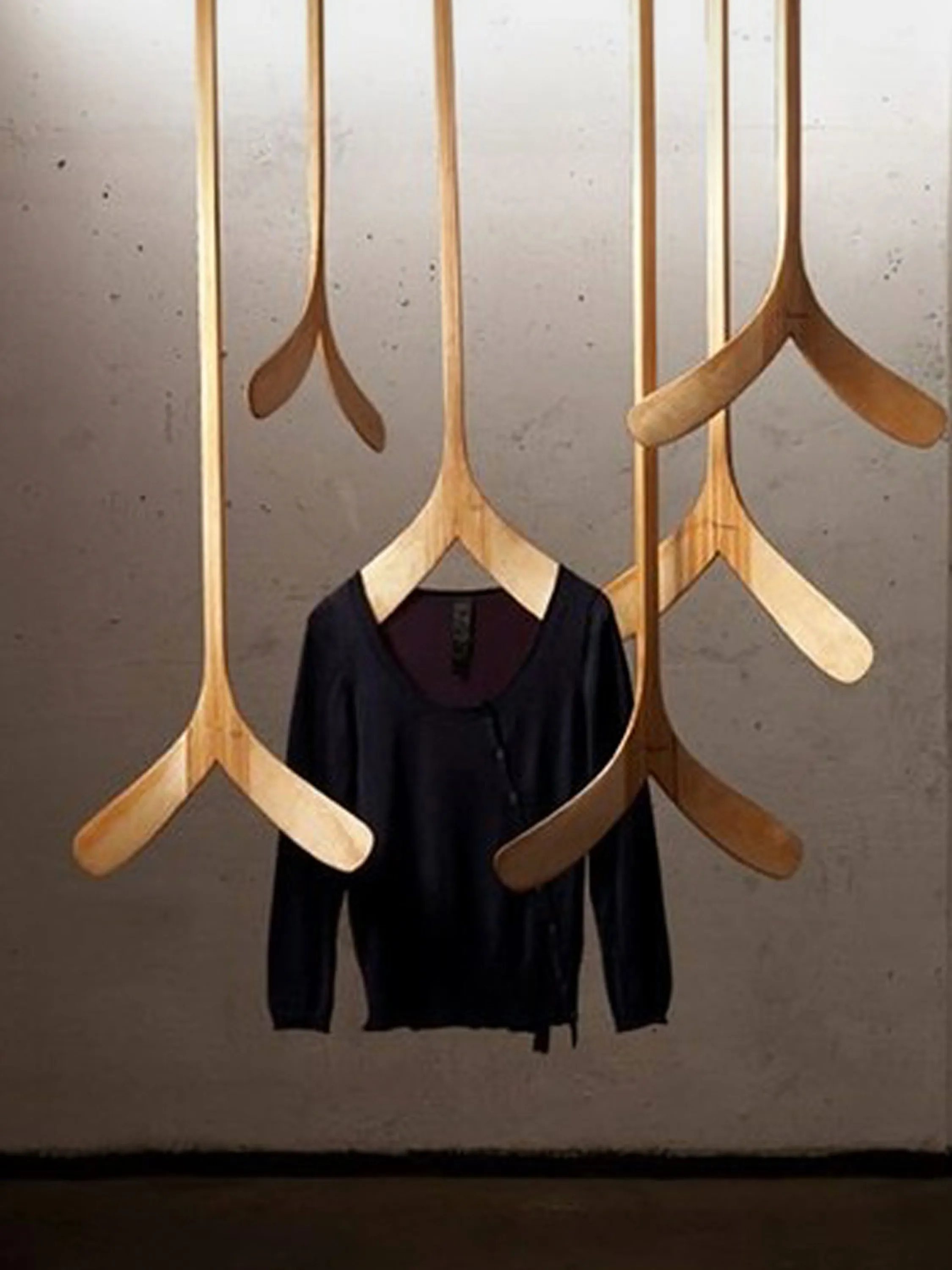 Organic wood clothes hangers mounted on the ceiling.