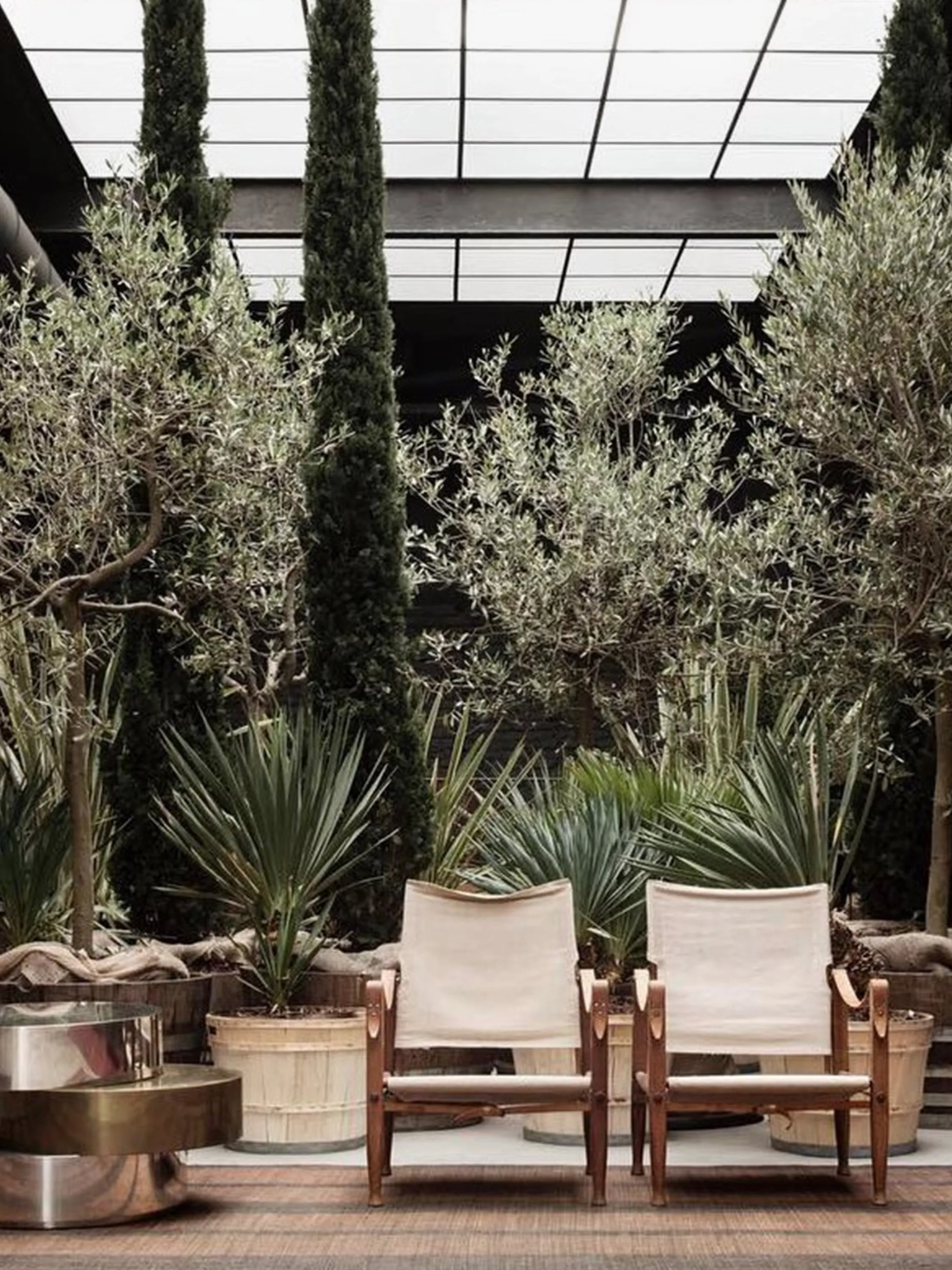 Seating area screened with a line of plants on the back.