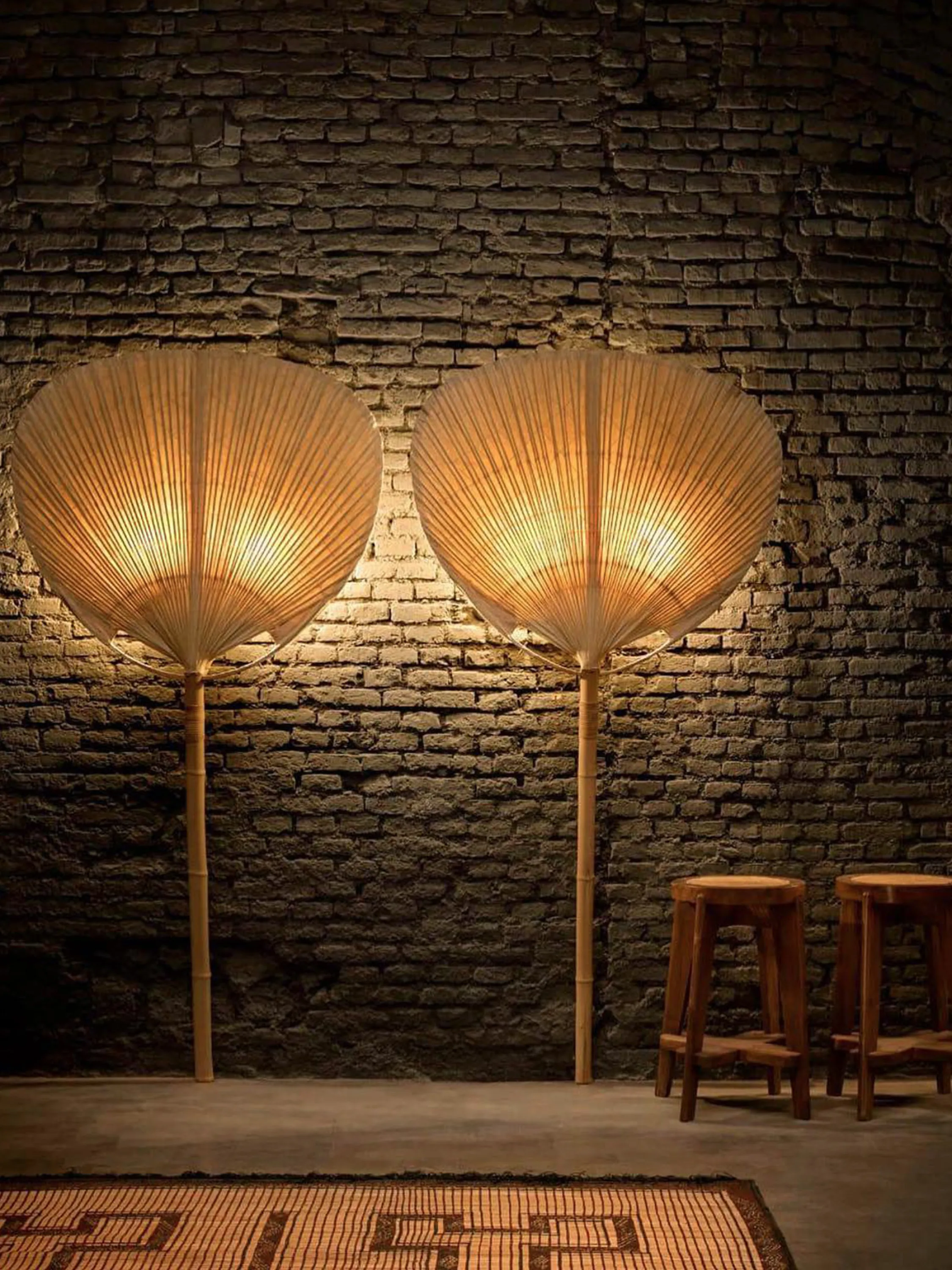 Straw fans diffuse the light from wall sconces.
