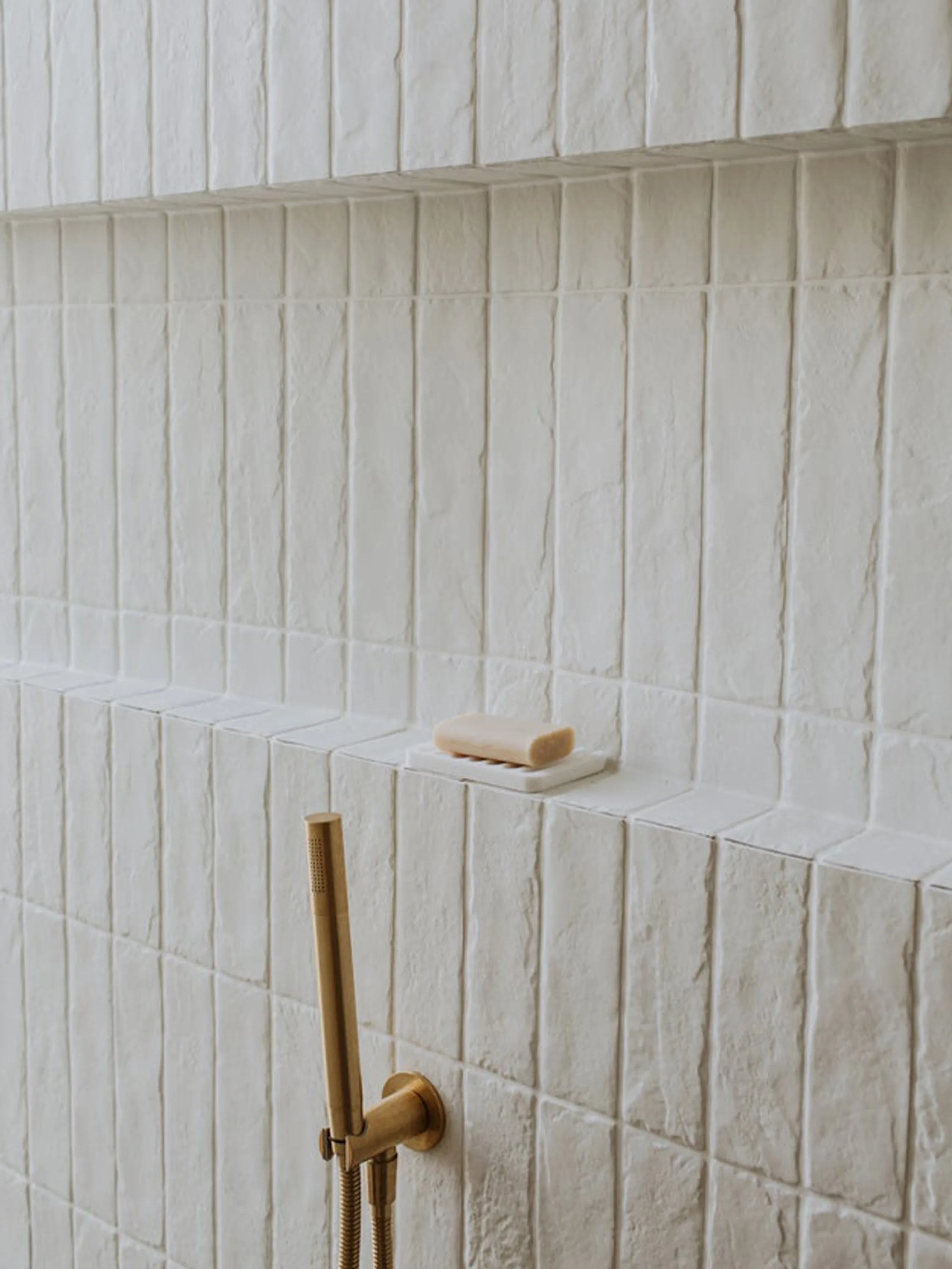 Close-up of textured bathroom tiles.