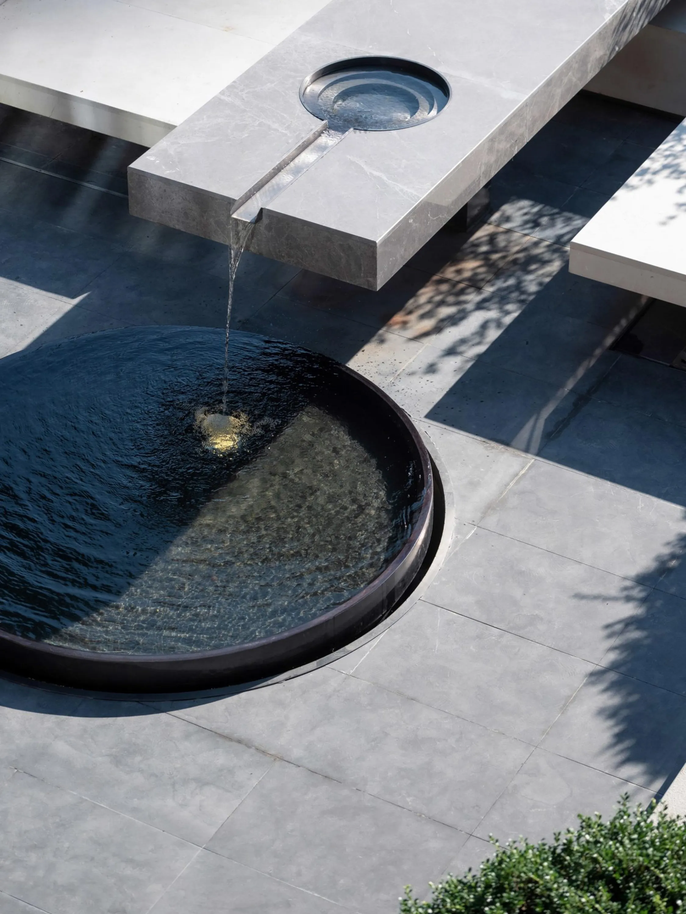 Outdoor seating area integrating a water feature.