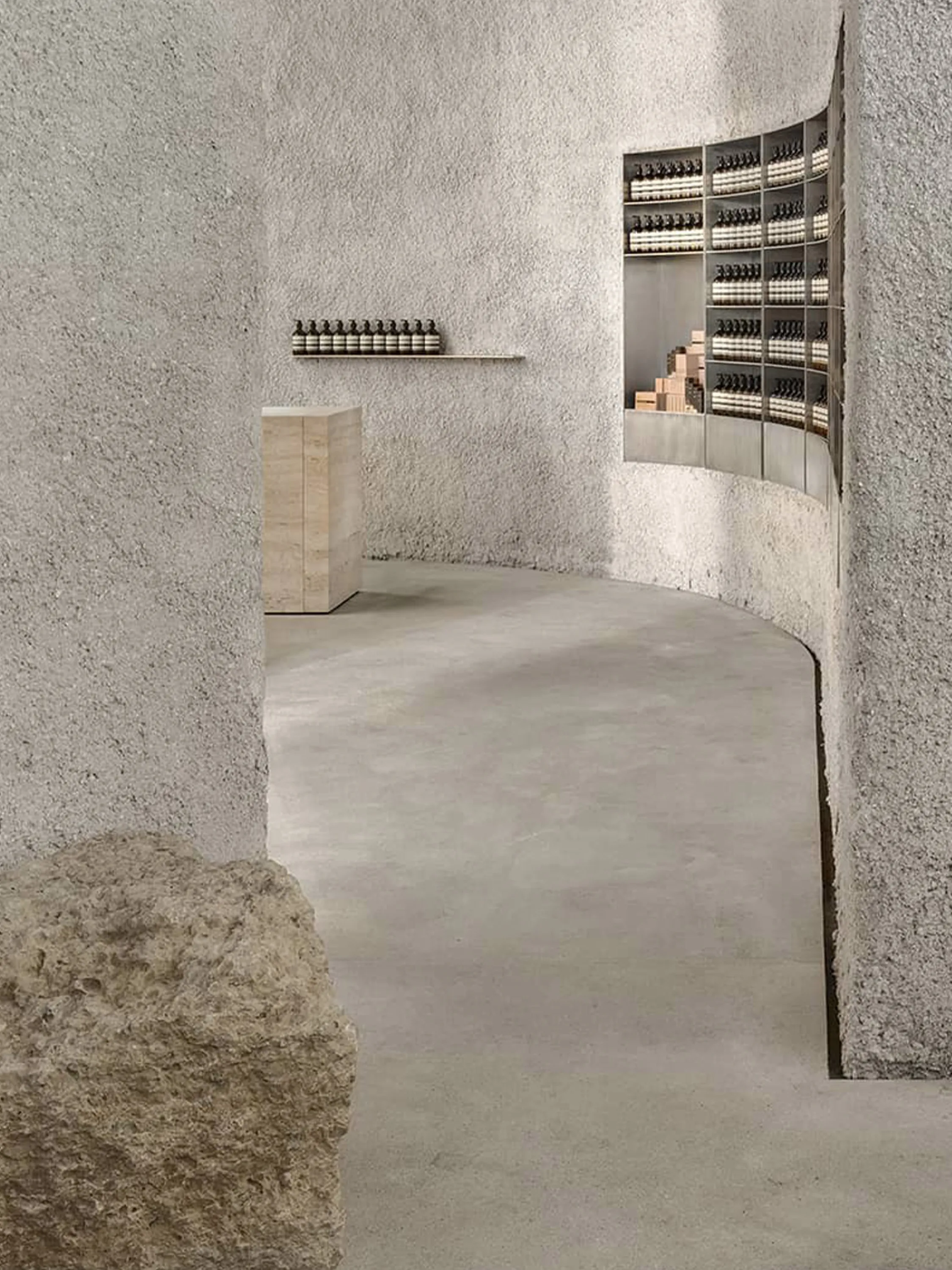 View of the curved wall leading guests to explore the space.