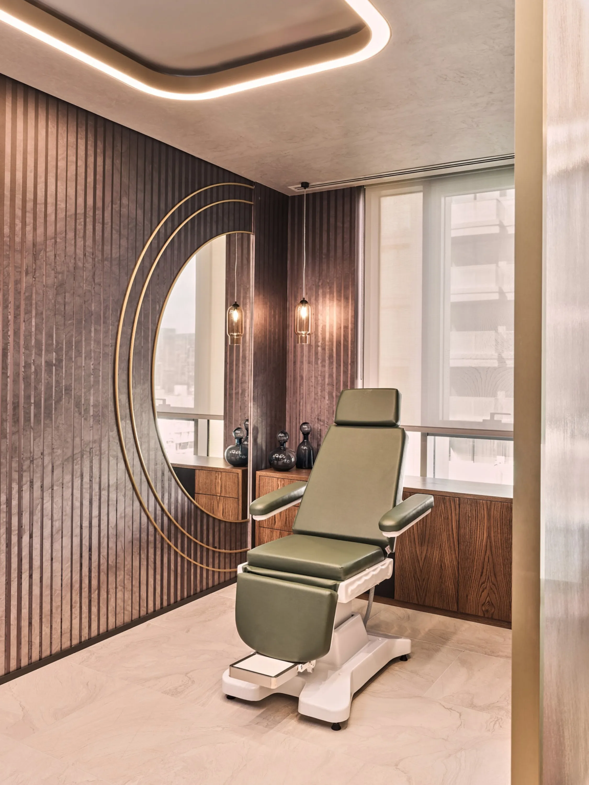 Treatment room with wood panelling on the wall and a grounding colour palette.