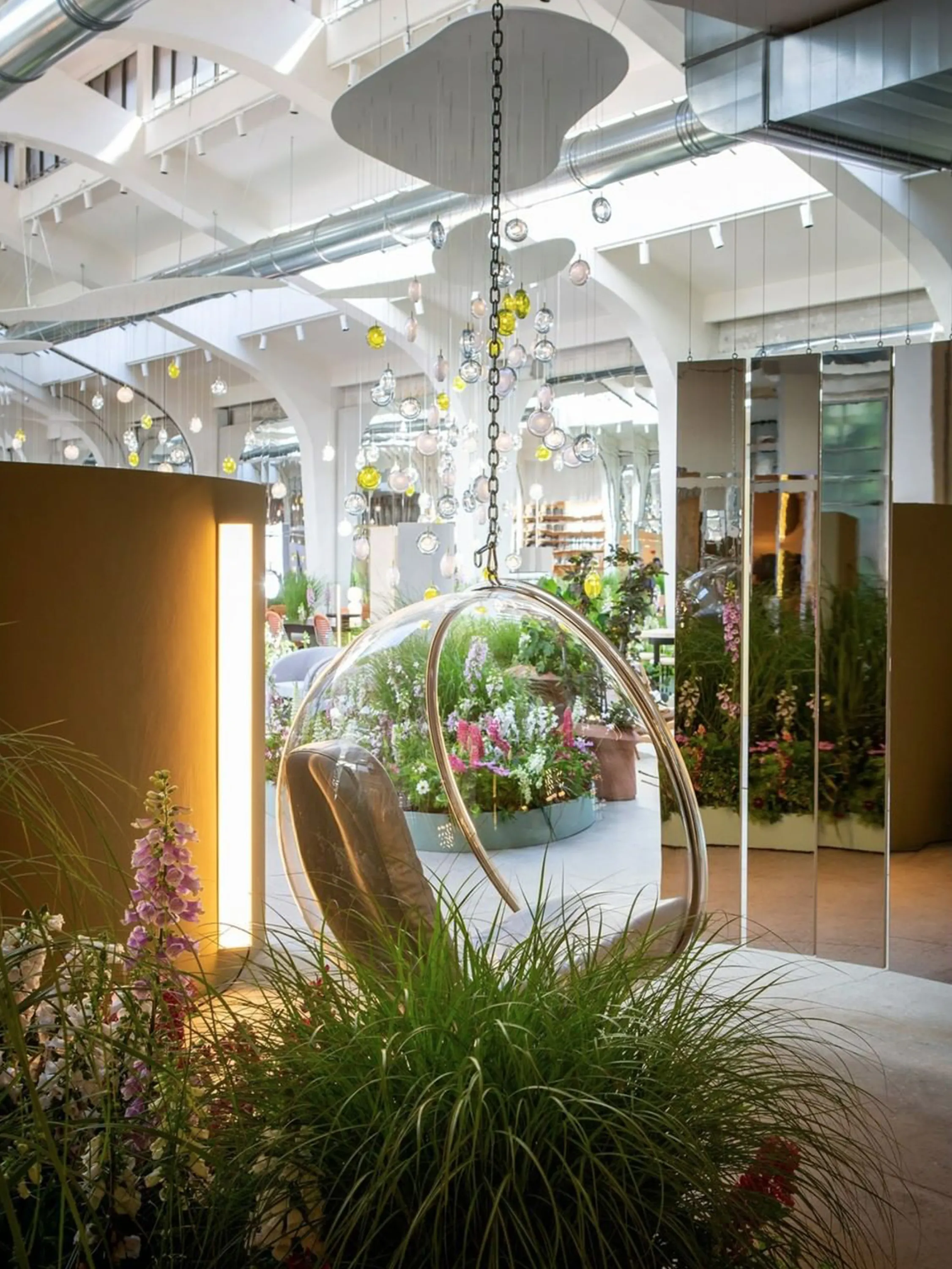 Furniture surrounded by greenery in a showroom.