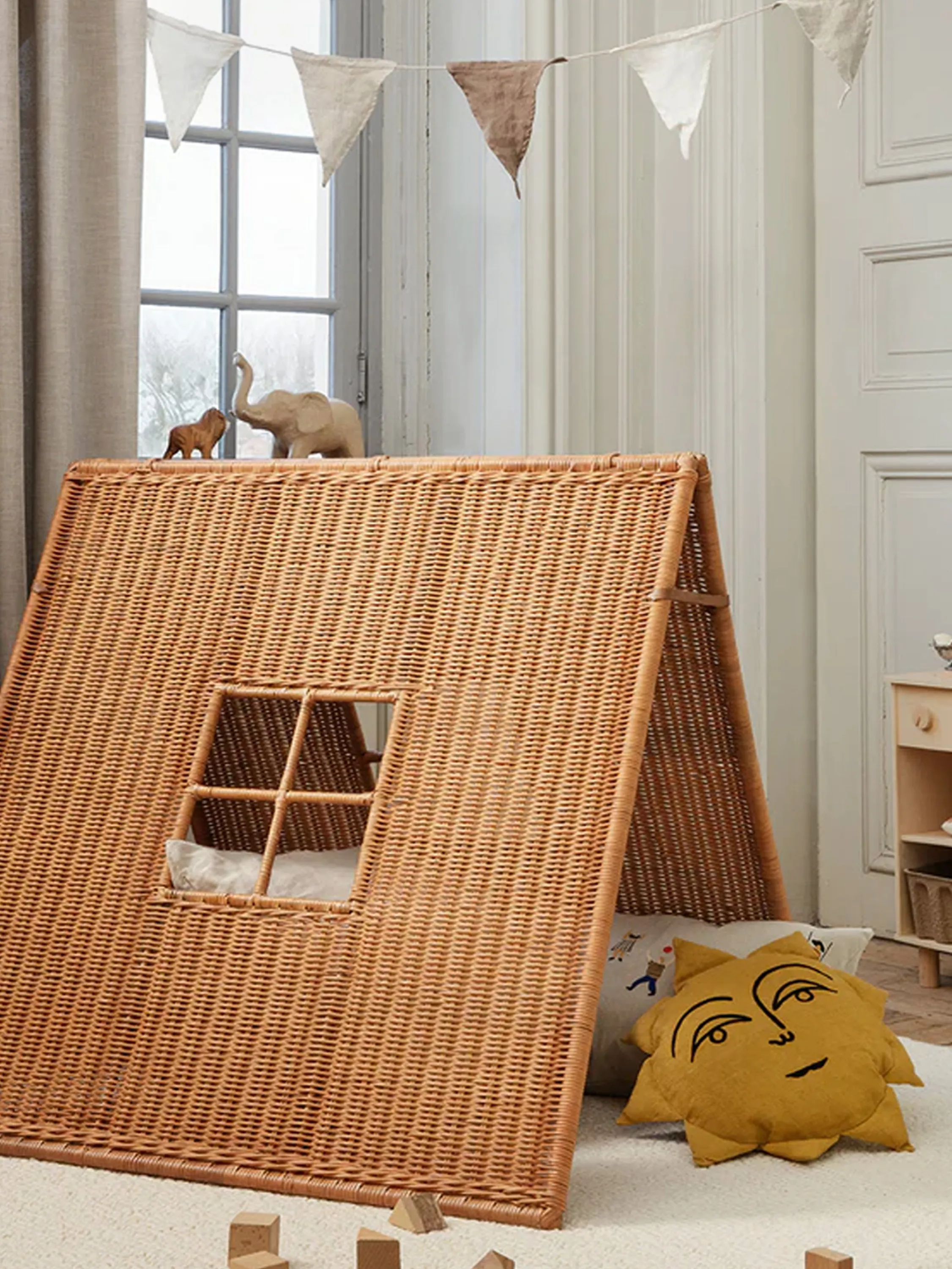Children's bedroom with woven rattan tent.
