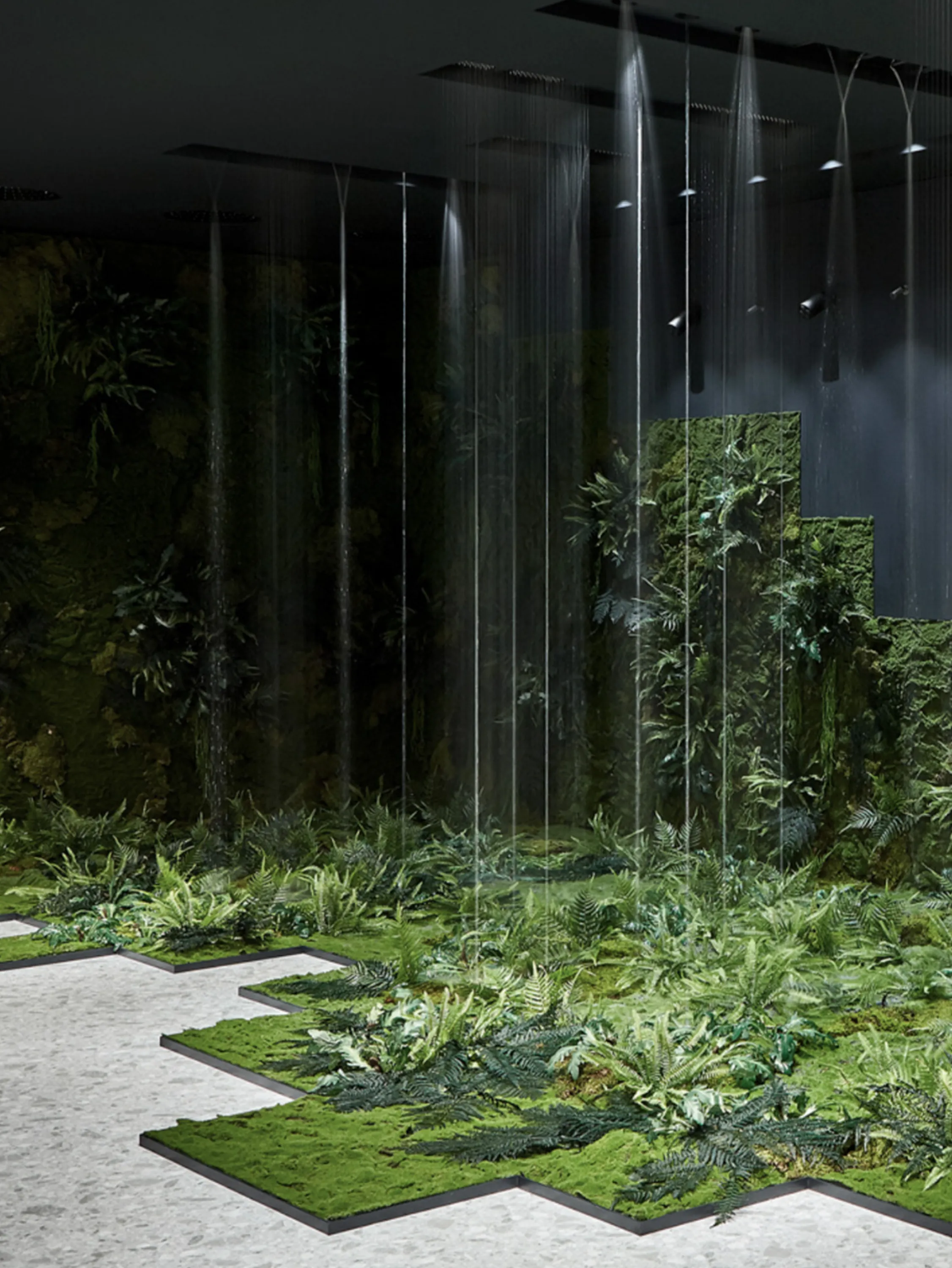Booth with water jets and lush vegetation.