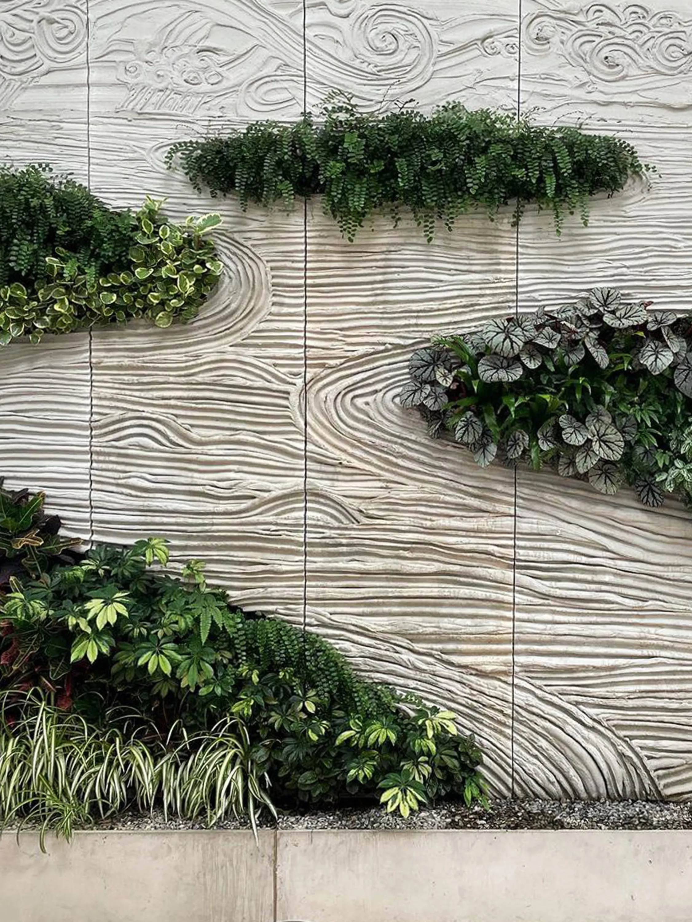 Textured wall with integrated vegetation.