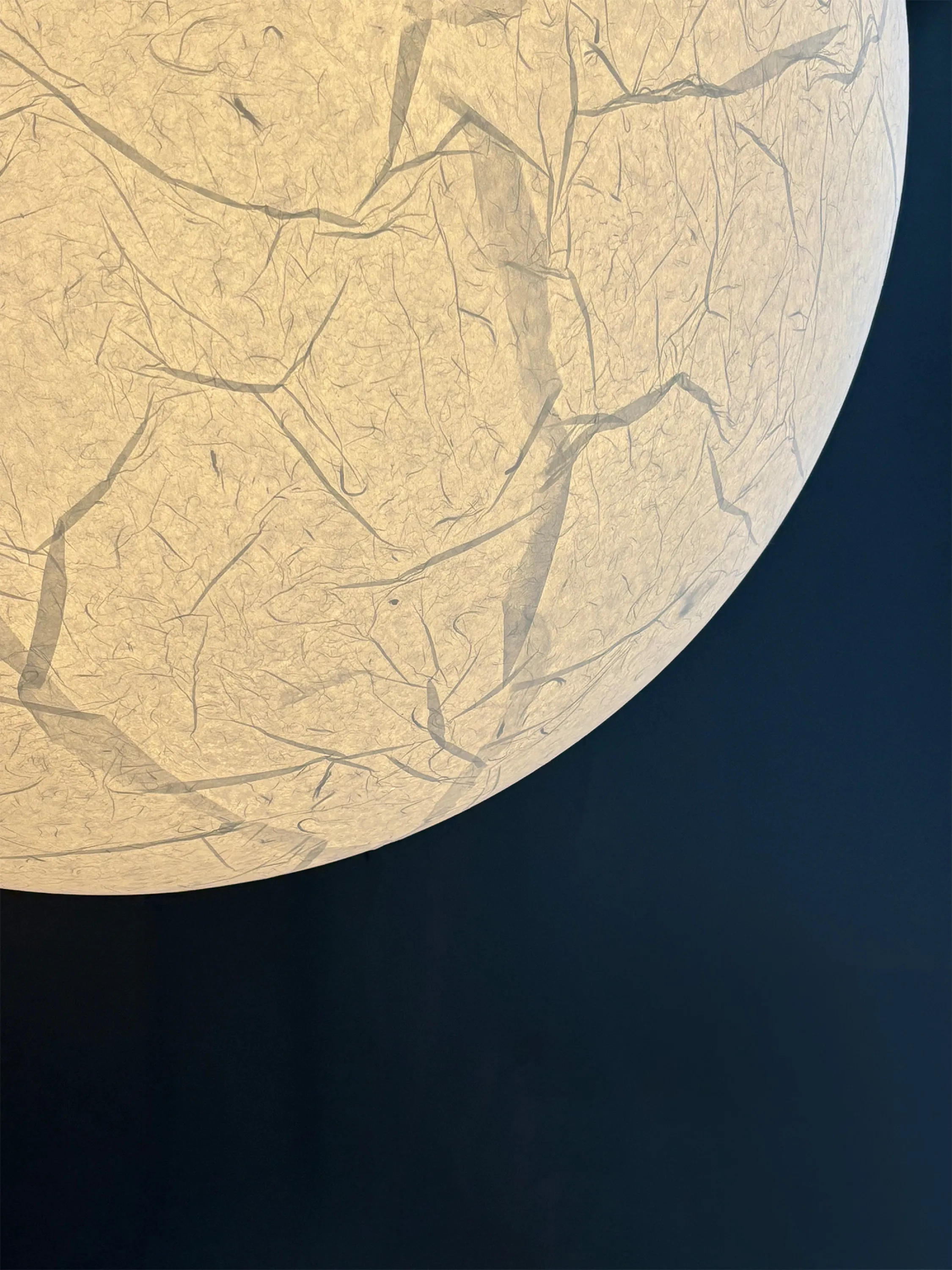 Light fixture with wrinkled paper surface.