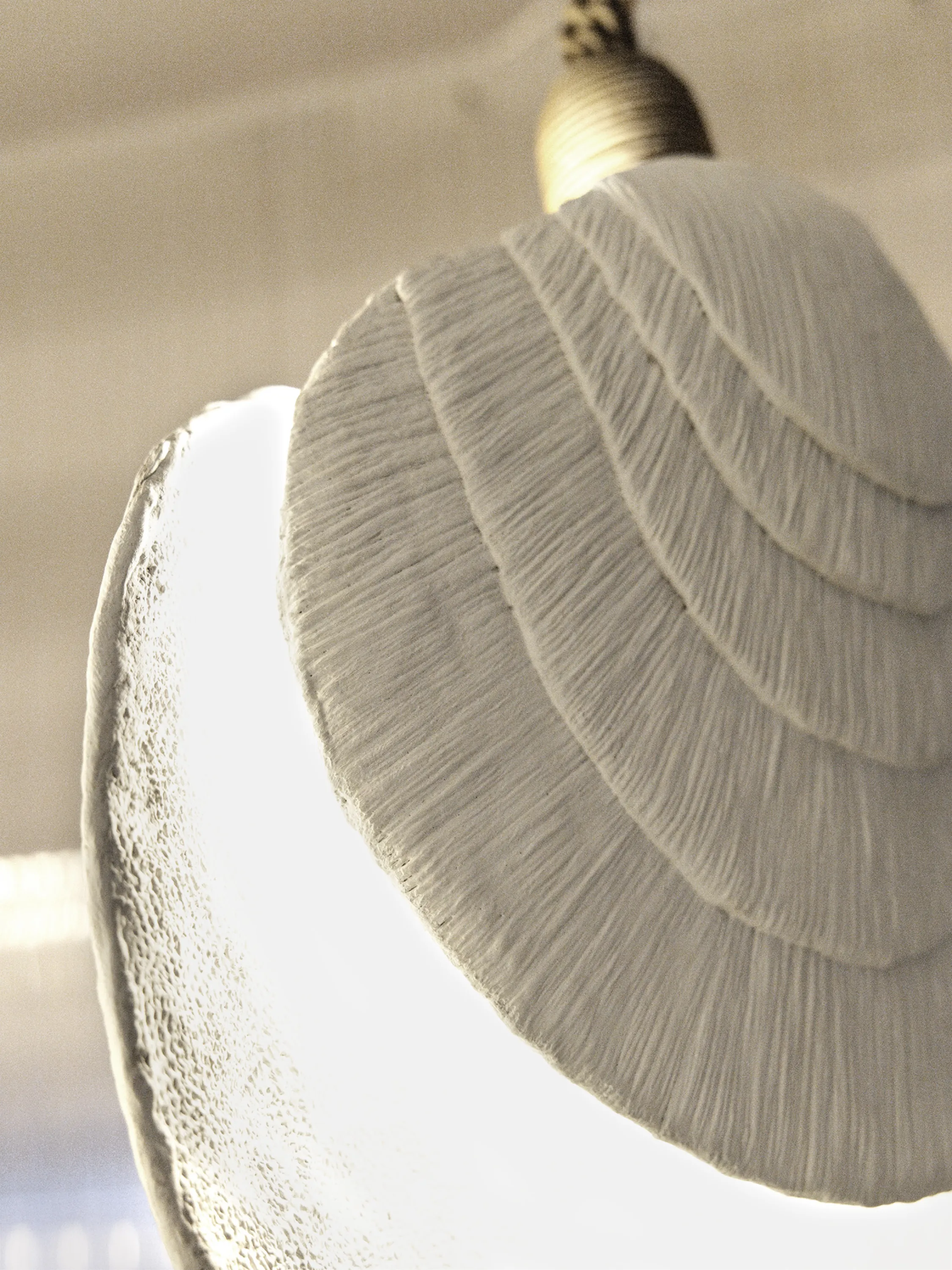 Shell shaped light fixture with rich texture.