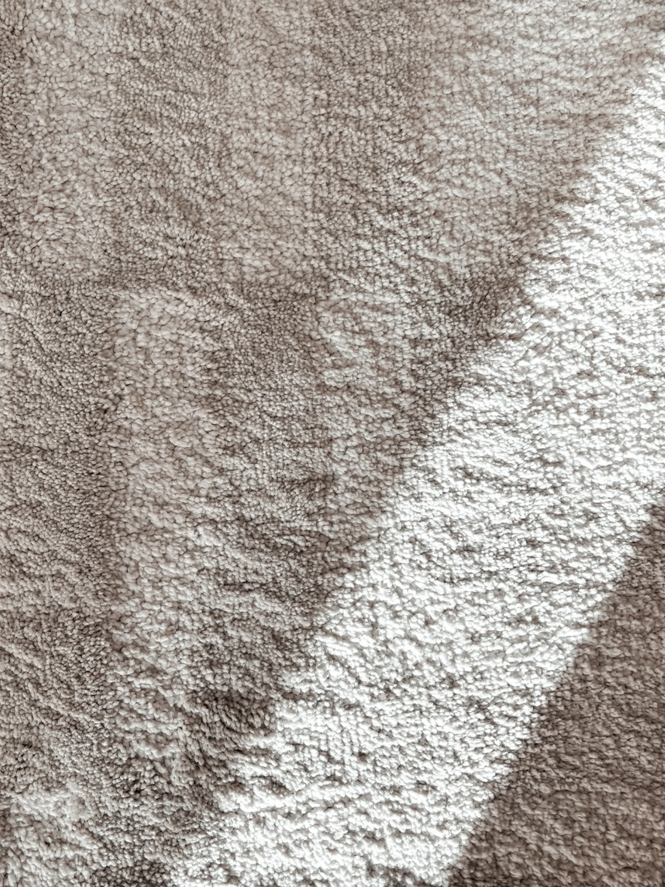 Sunlight drawing shapes on a textured rug.