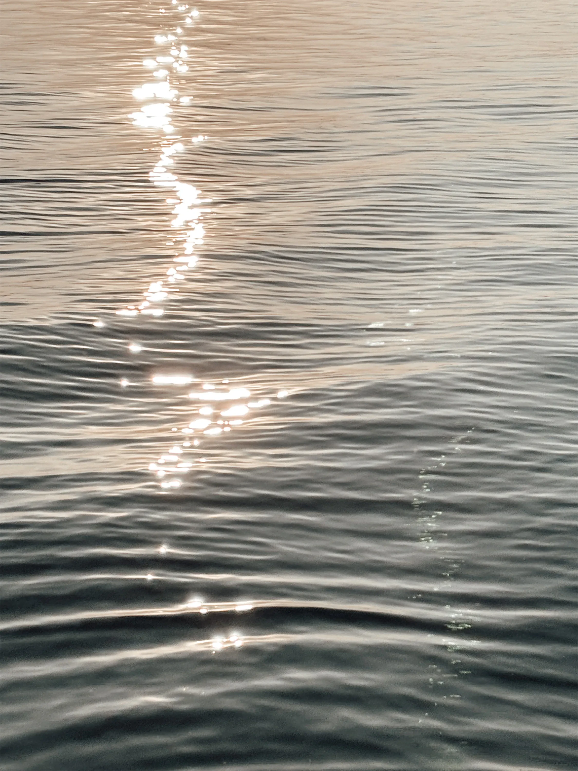 A rippled water surface at sunset.