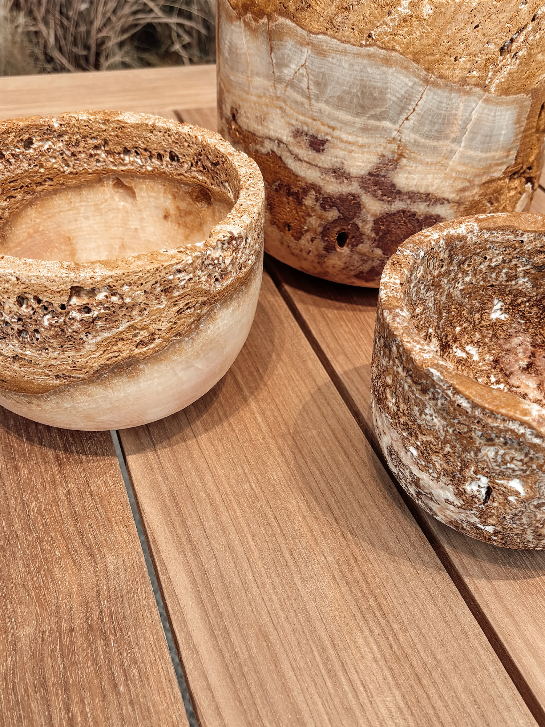 Stone vessels on a wood table.