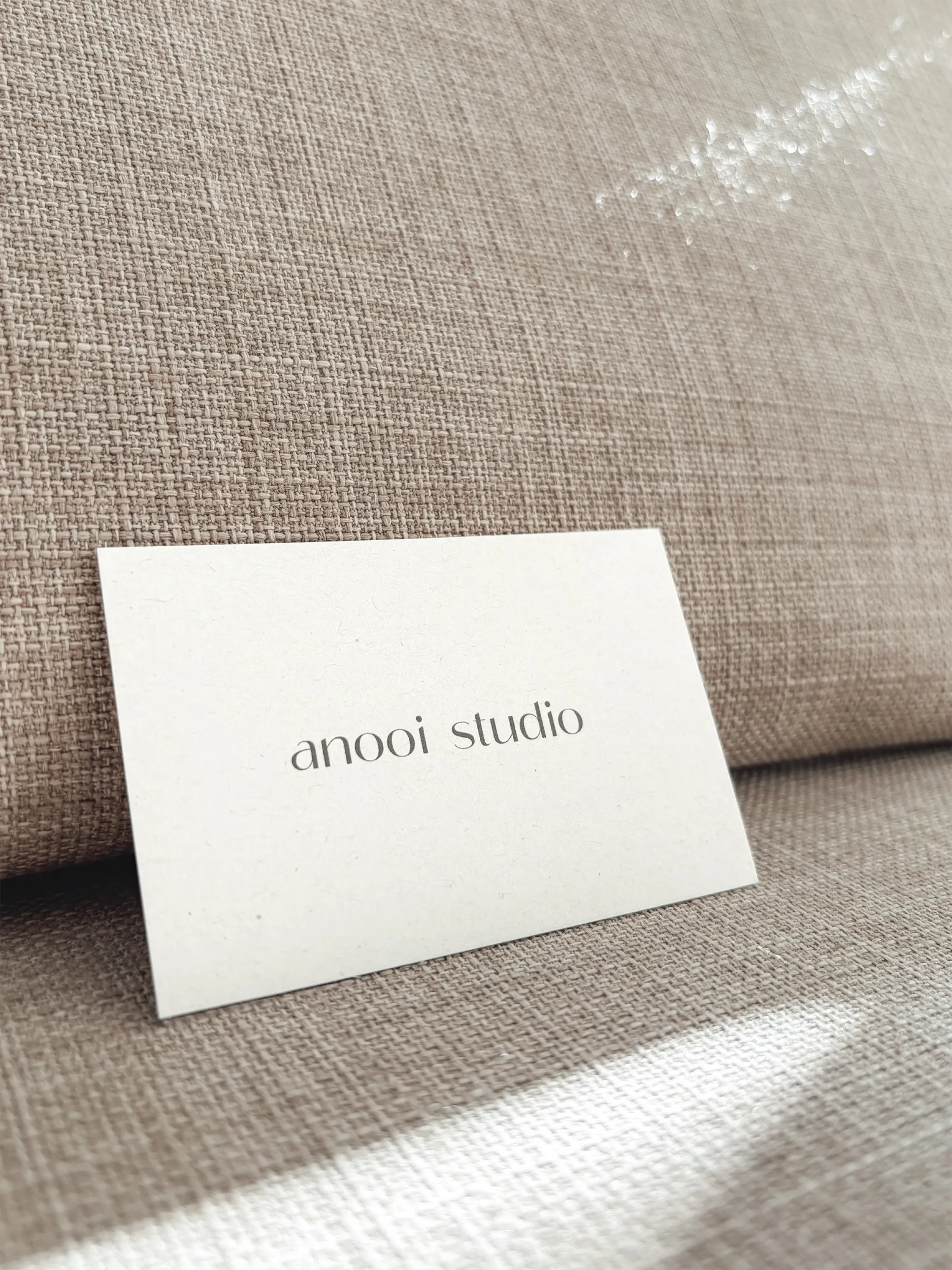 anooi studio business cards in the sun.