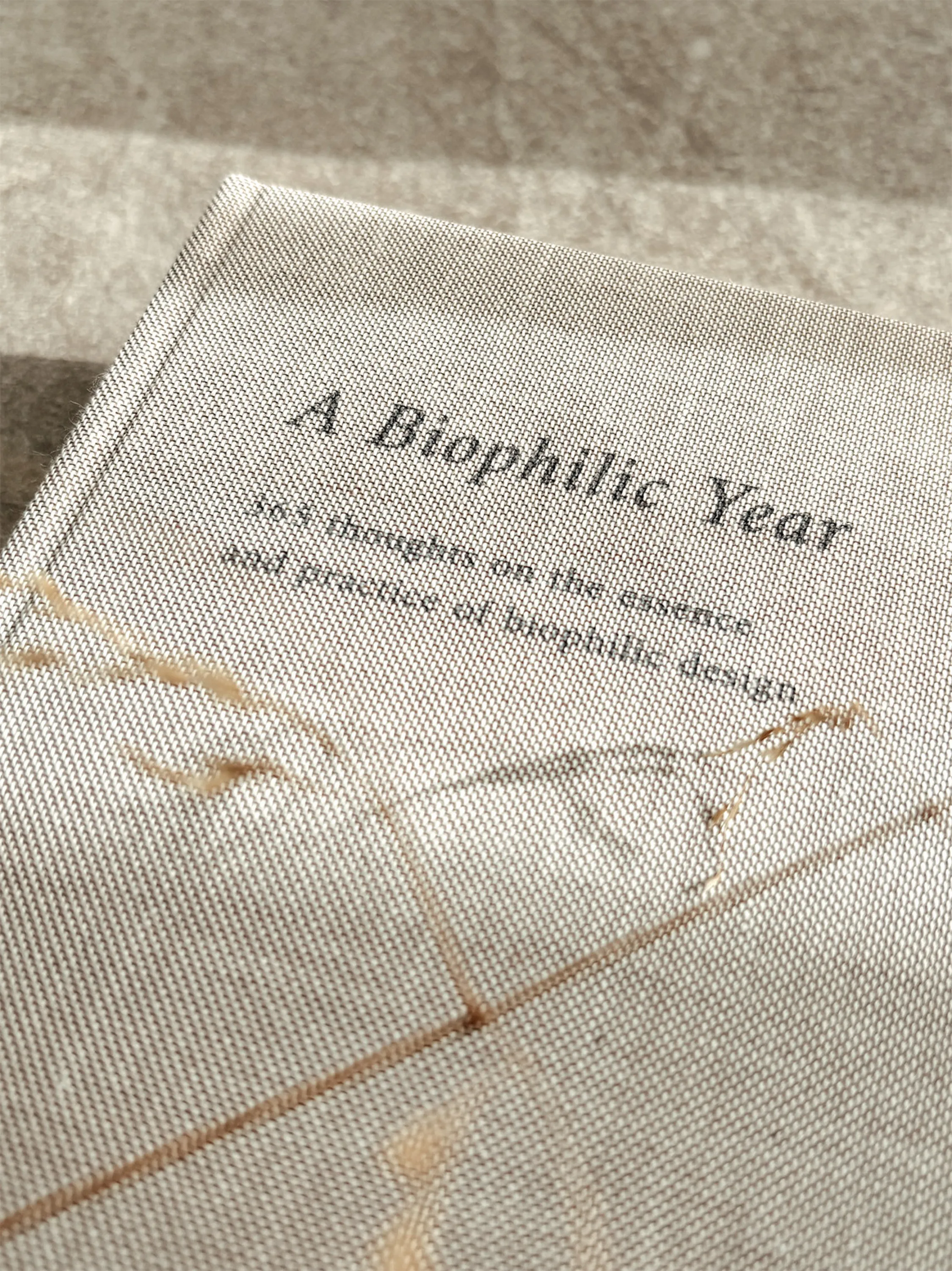 Close up of the tactile cotton cover of A Biophilic Year.