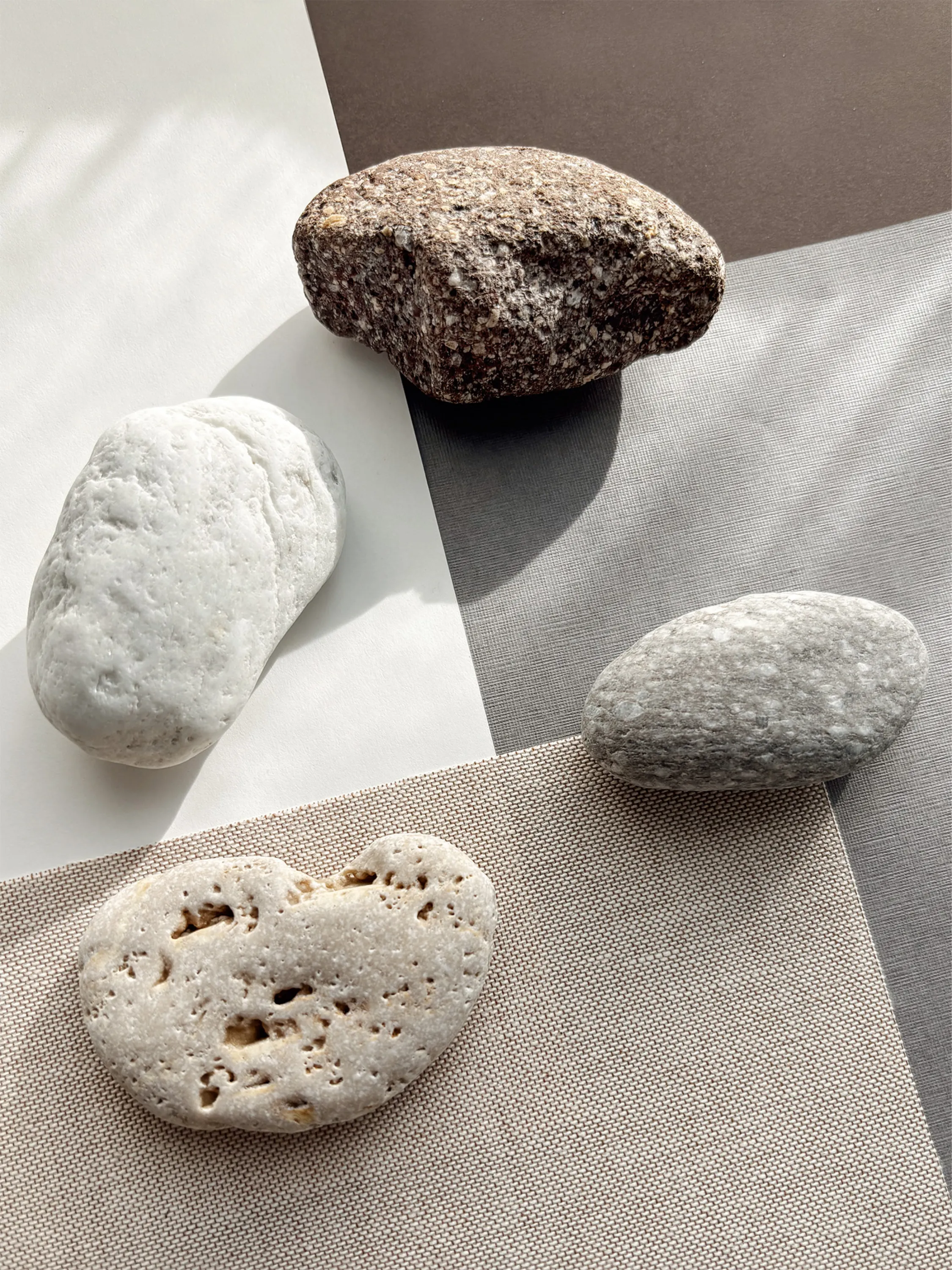 Stones and papers that echo their colours.