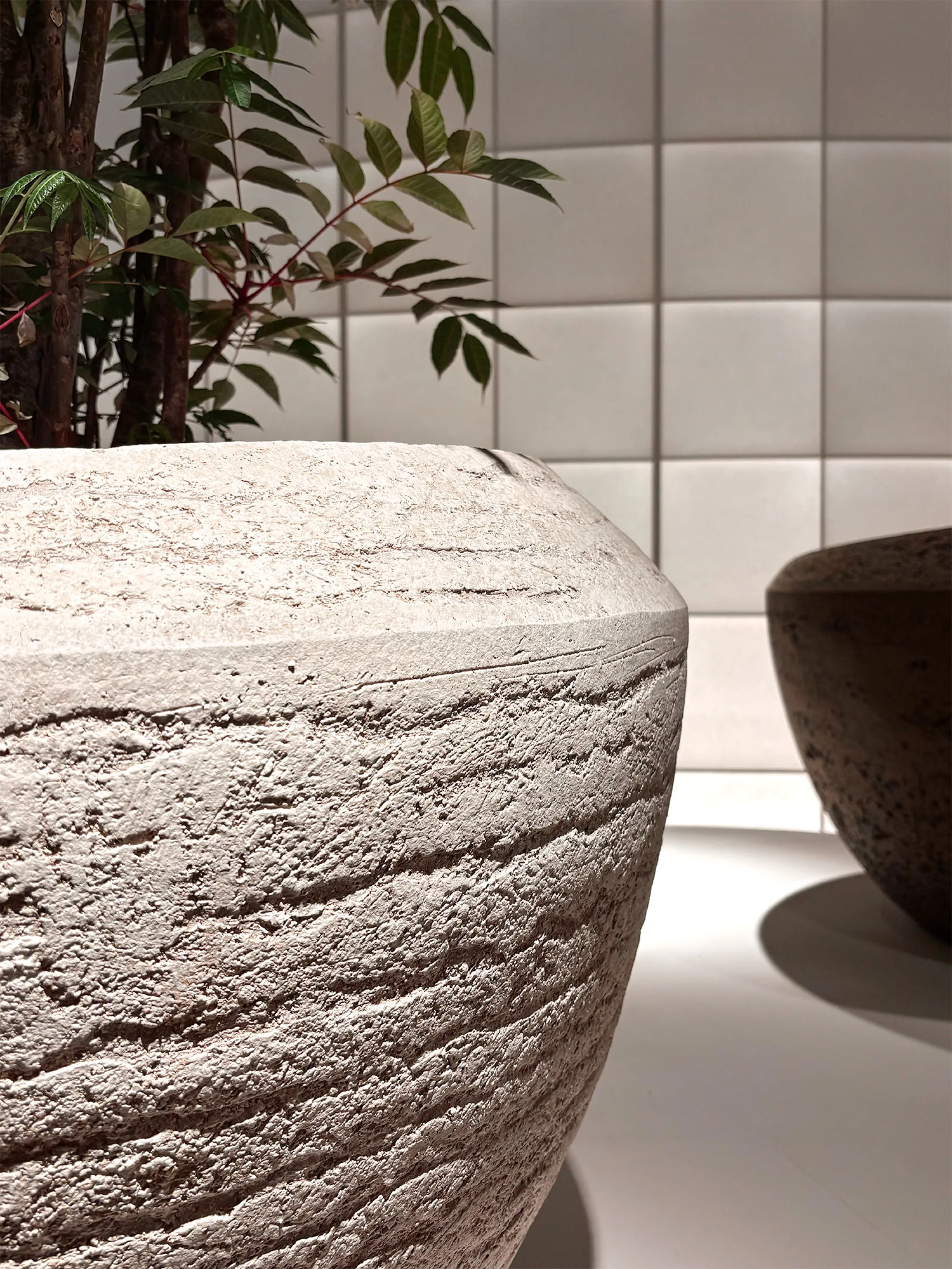 Oversized vases with marked tactile surface.