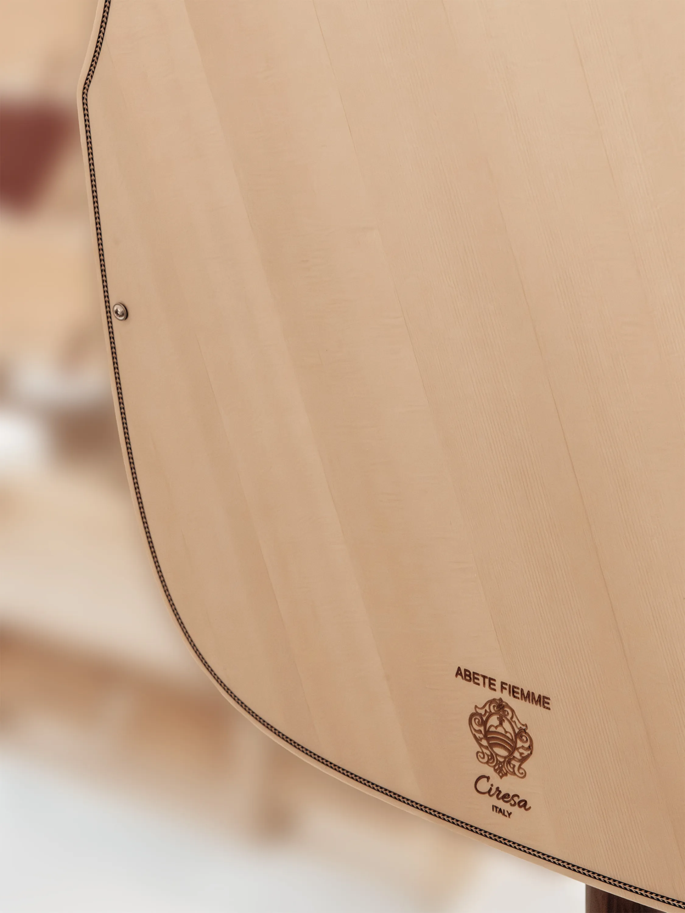 Detail of a speaker diffusing sound solely thanks to the natural resonance of wood fibres.