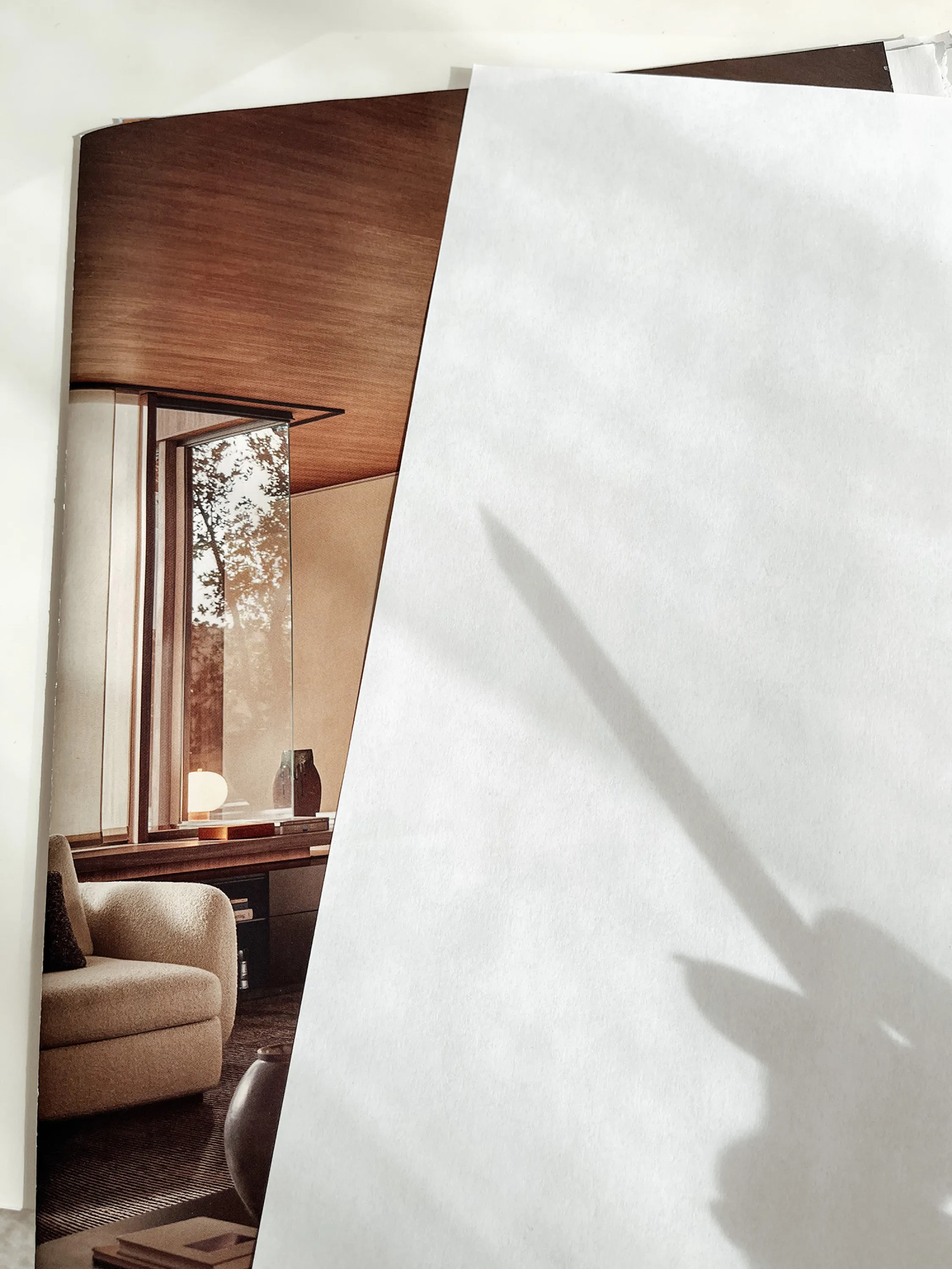 Reflection of a pencil on a white page.