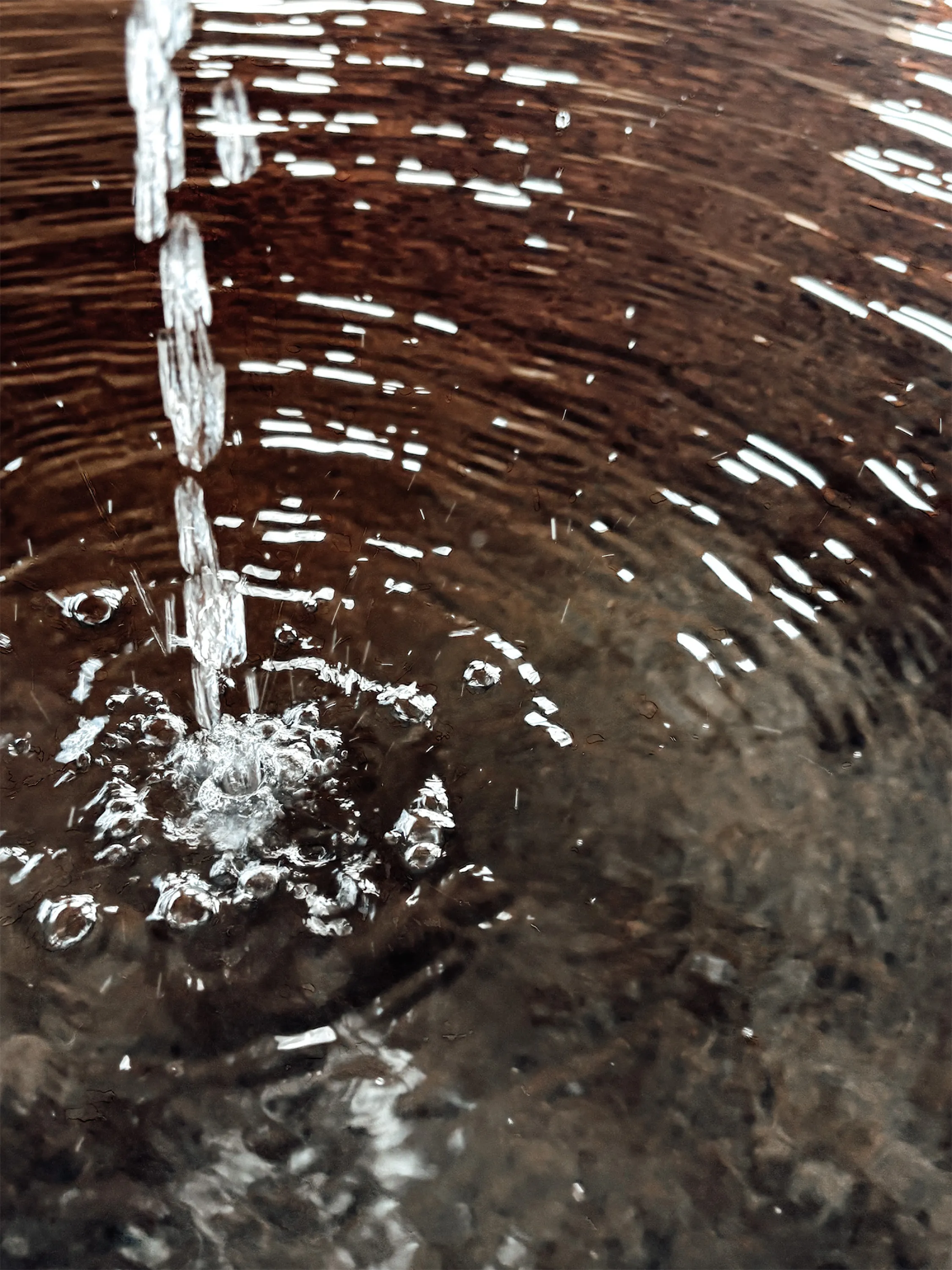 Water moving through a stone courtyard fountain.