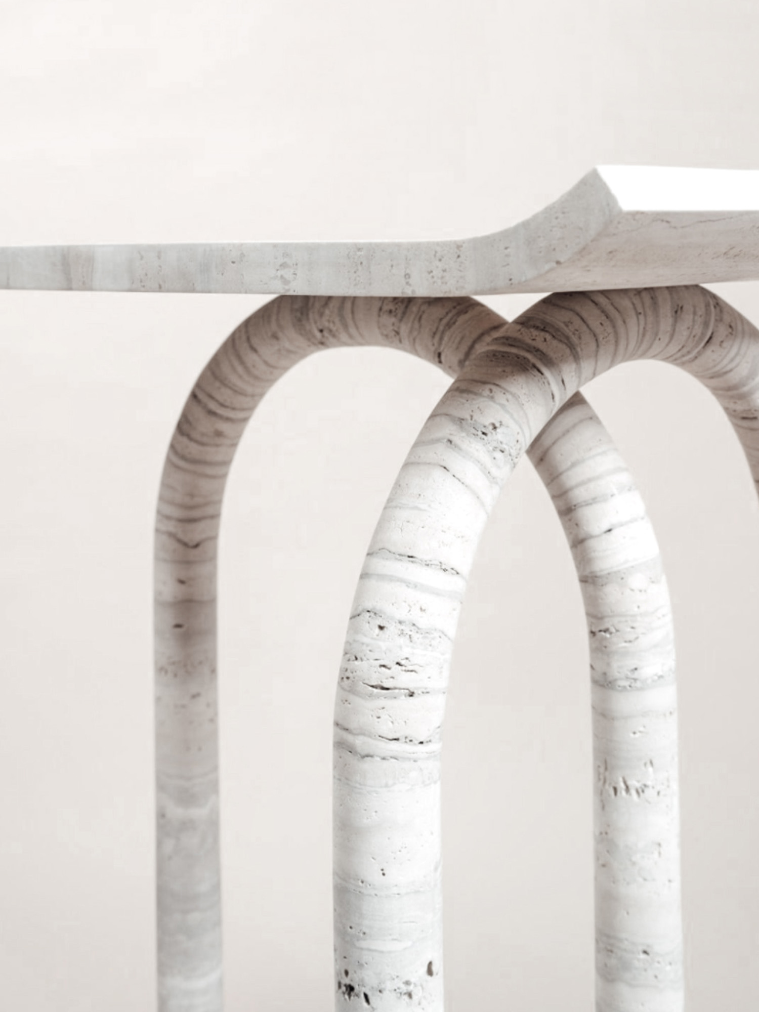 Sculptural travertine side table with arched legs