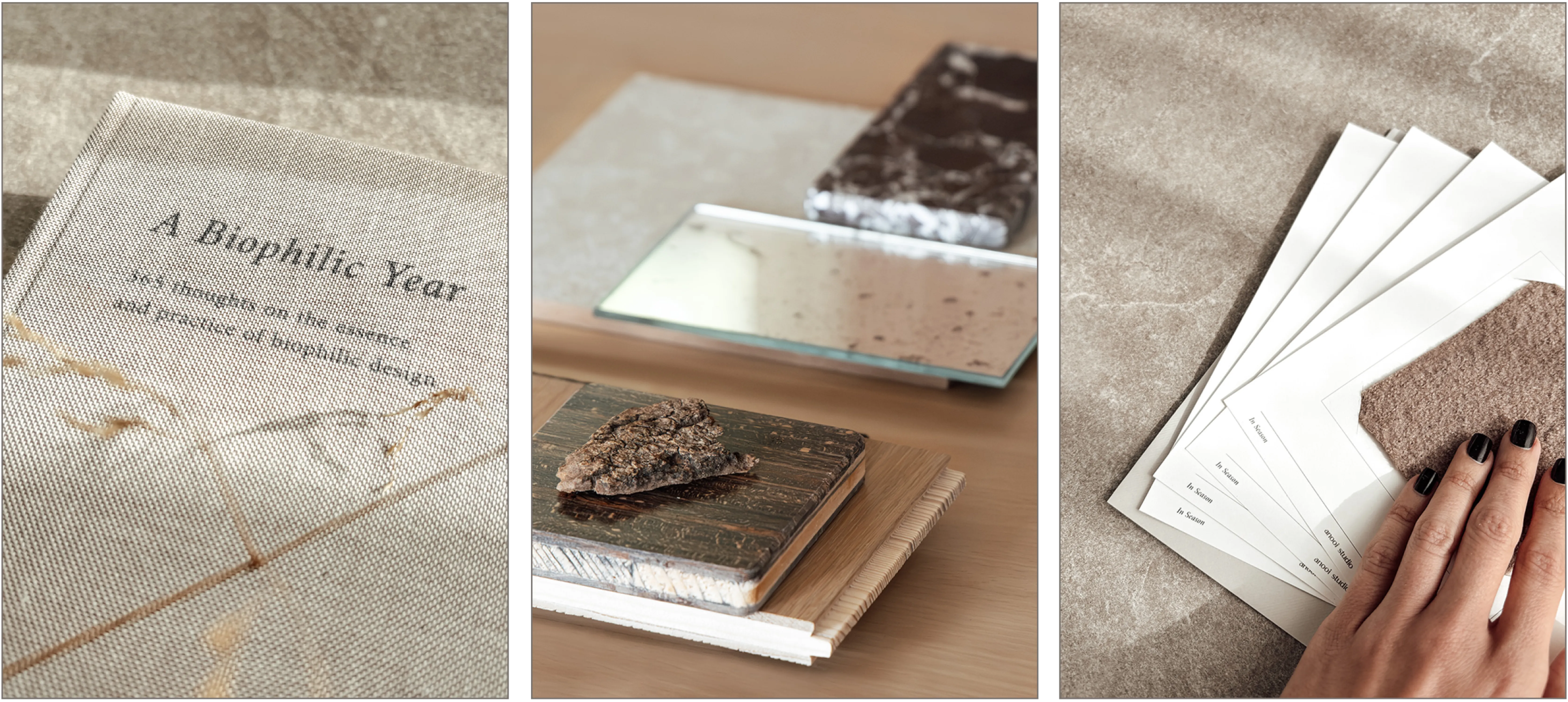 The book A Biophilic Year. A fragment of bark resting on a dark wood sample, beside mirror and stone tiles. A hand resting on the wool sample of an In Season card, cards fanned on a stone surface.